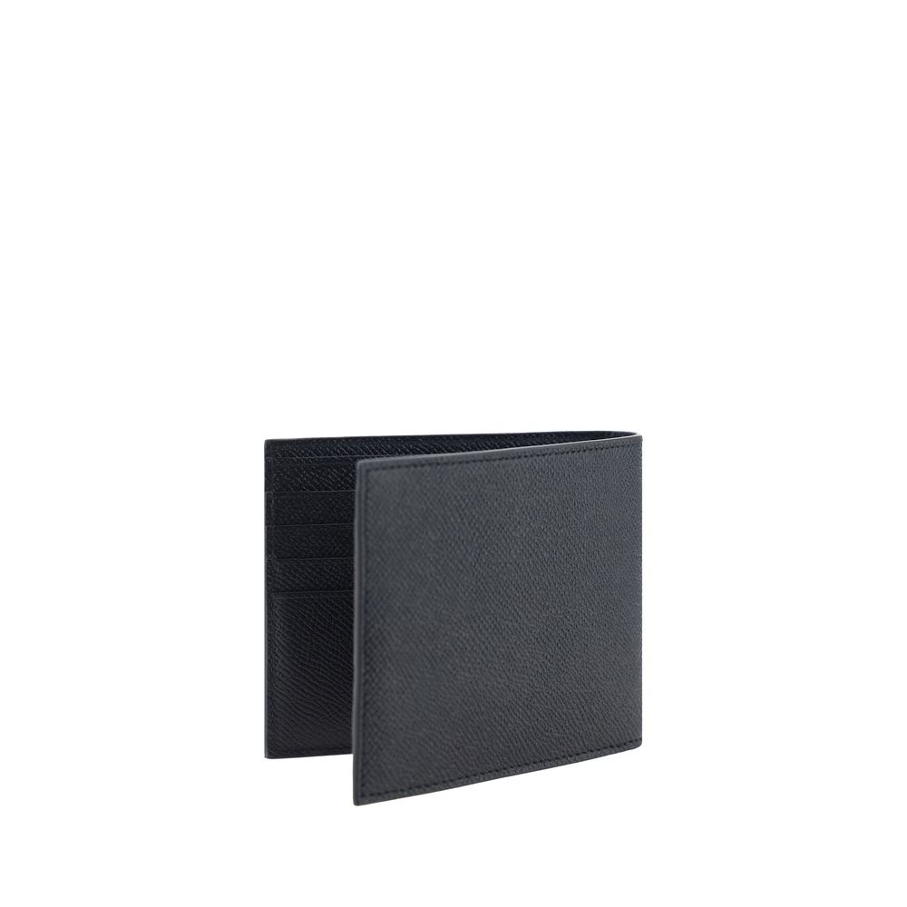 Experience the exquisite craftsmanship of the Ferragamo Black Calf Leather Bos Taurus Wallet, a timeless accessory that embodies luxury and sophistication for discerning individuals.