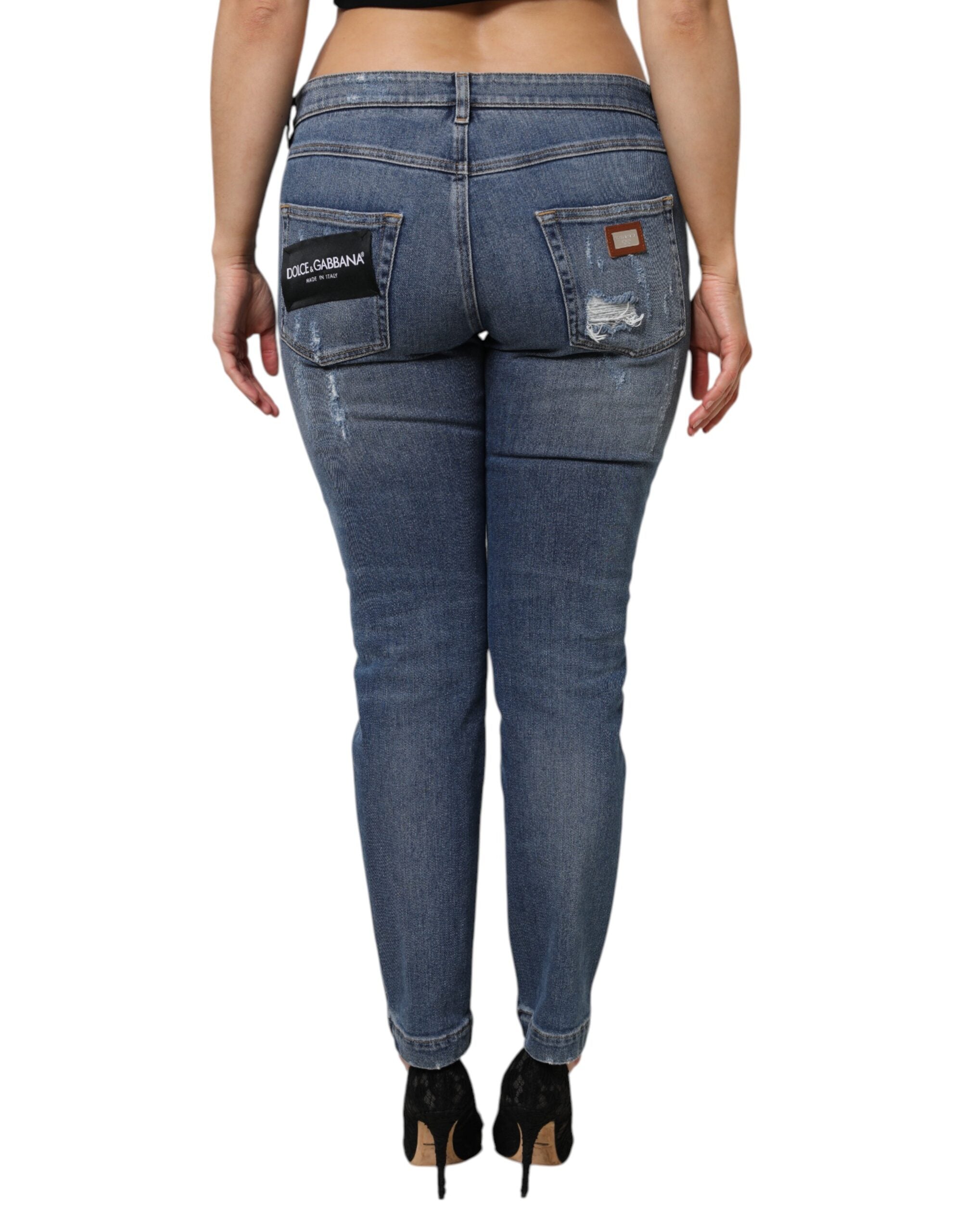 Indulge in the exquisite allure of Dolce & Gabbana's Blue Tattered Cotton Low Waist Denim Jeans, where Italian craftsmanship meets modern elegance for a timeless statement.