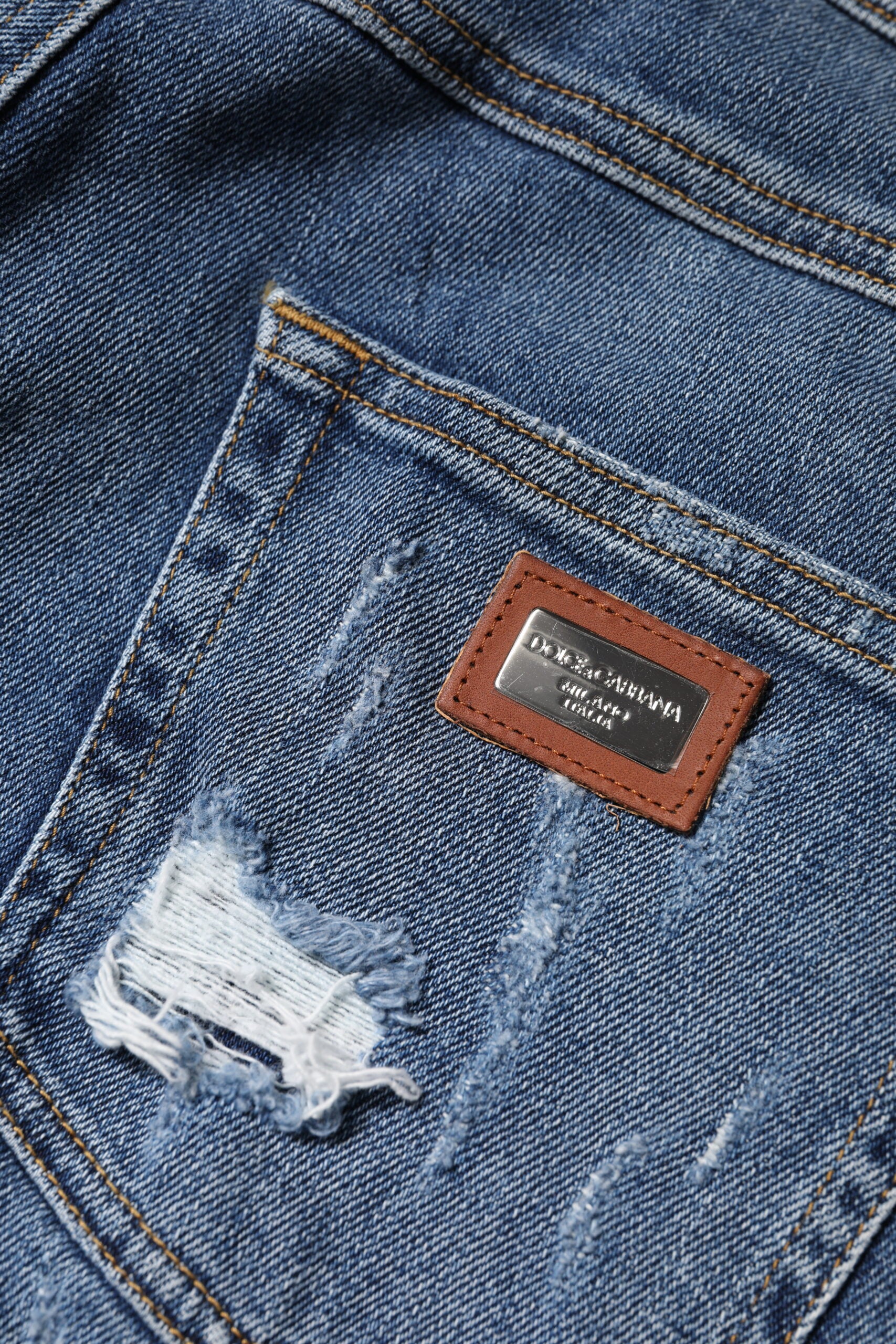 Indulge in the exquisite allure of Dolce & Gabbana's Blue Tattered Cotton Low Waist Denim Jeans, where Italian craftsmanship meets modern elegance for the discerning individual.