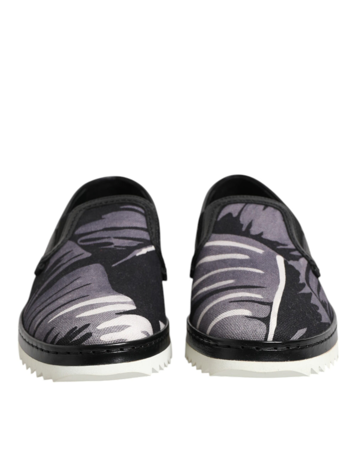 Indulge in the exquisite Dolce & Gabbana Black Tropical Slip On Sneakers, where luxurious cotton and leather meet Italian craftsmanship for timeless elegance and effortless style.