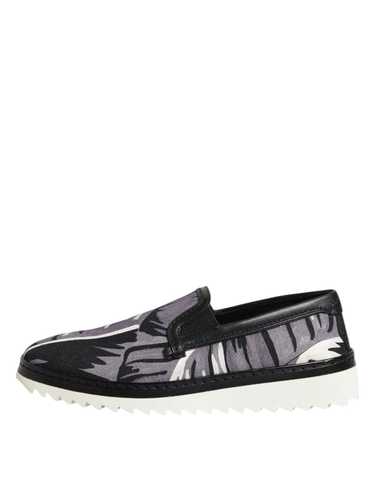 Indulge in the exquisite Dolce & Gabbana Black Tropical Slip On Sneakers, where luxurious cotton and leather craftsmanship meets timeless elegance for every discerning moment.