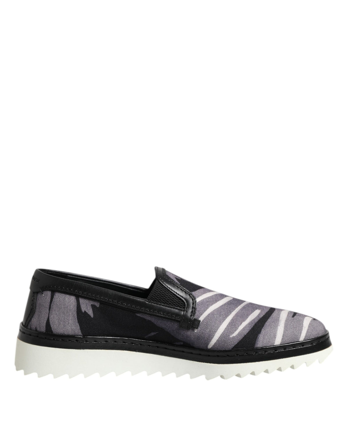 Indulge in the exquisite Dolce & Gabbana Black Tropical Slip On Sneakers, where luxurious cotton and leather unite, embodying sophistication and effortless style for the discerning individual.