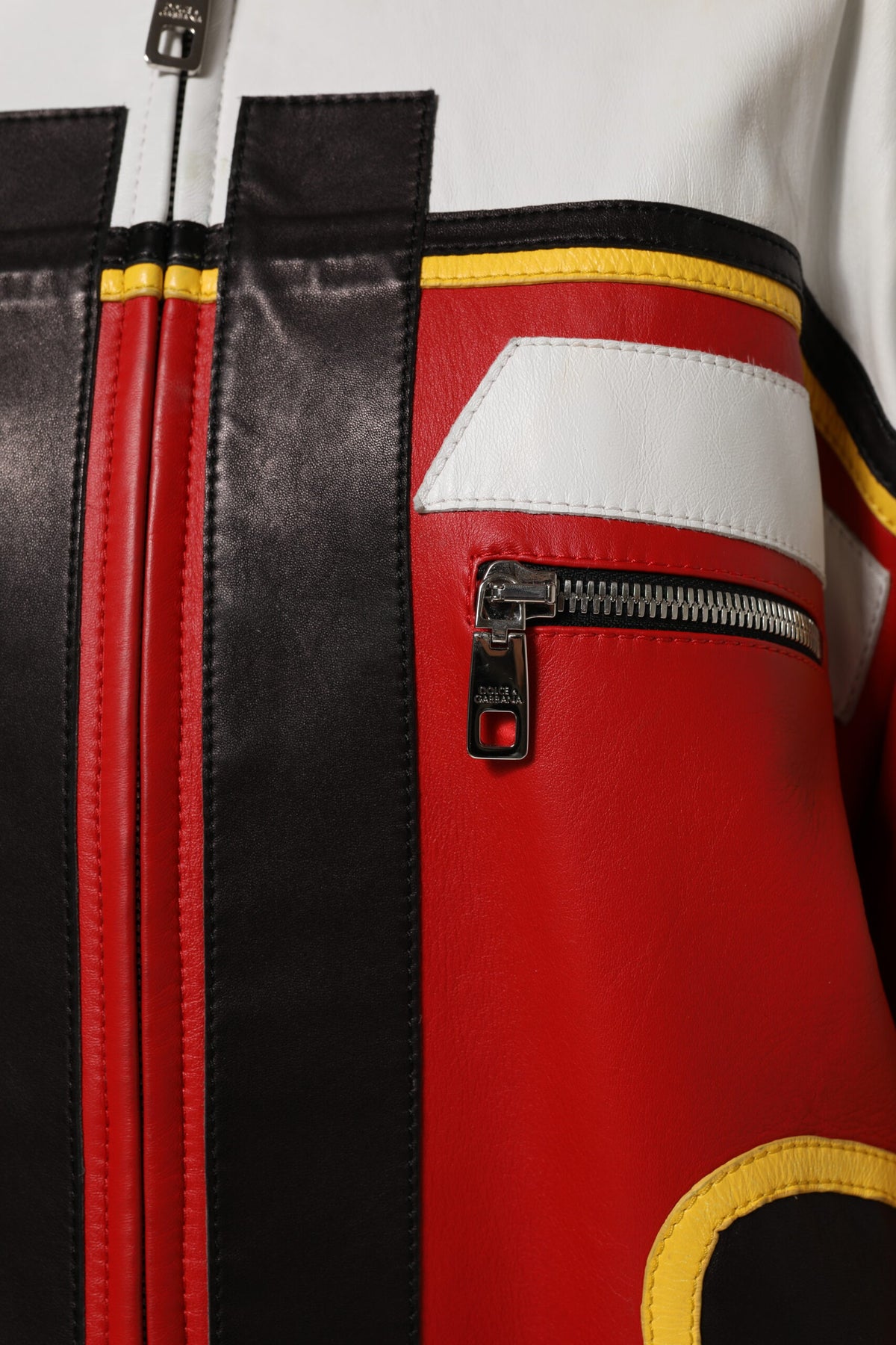 Indulge in the exquisite Dolce & Gabbana Multicolor Leather Biker Full Zip Coat Jacket, a timeless masterpiece of Italian craftsmanship, blending luxurious lambskin with bold artistry for the discerning individual.