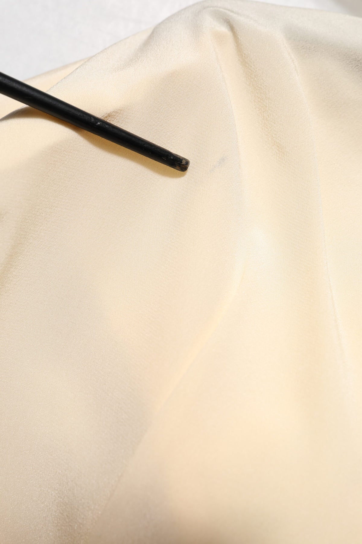 Elevate your wardrobe with the Dolce & Gabbana Light Yellow Silk Ascot Collared Blouse, a limited edition masterpiece that embodies exquisite Italian craftsmanship and timeless elegance.