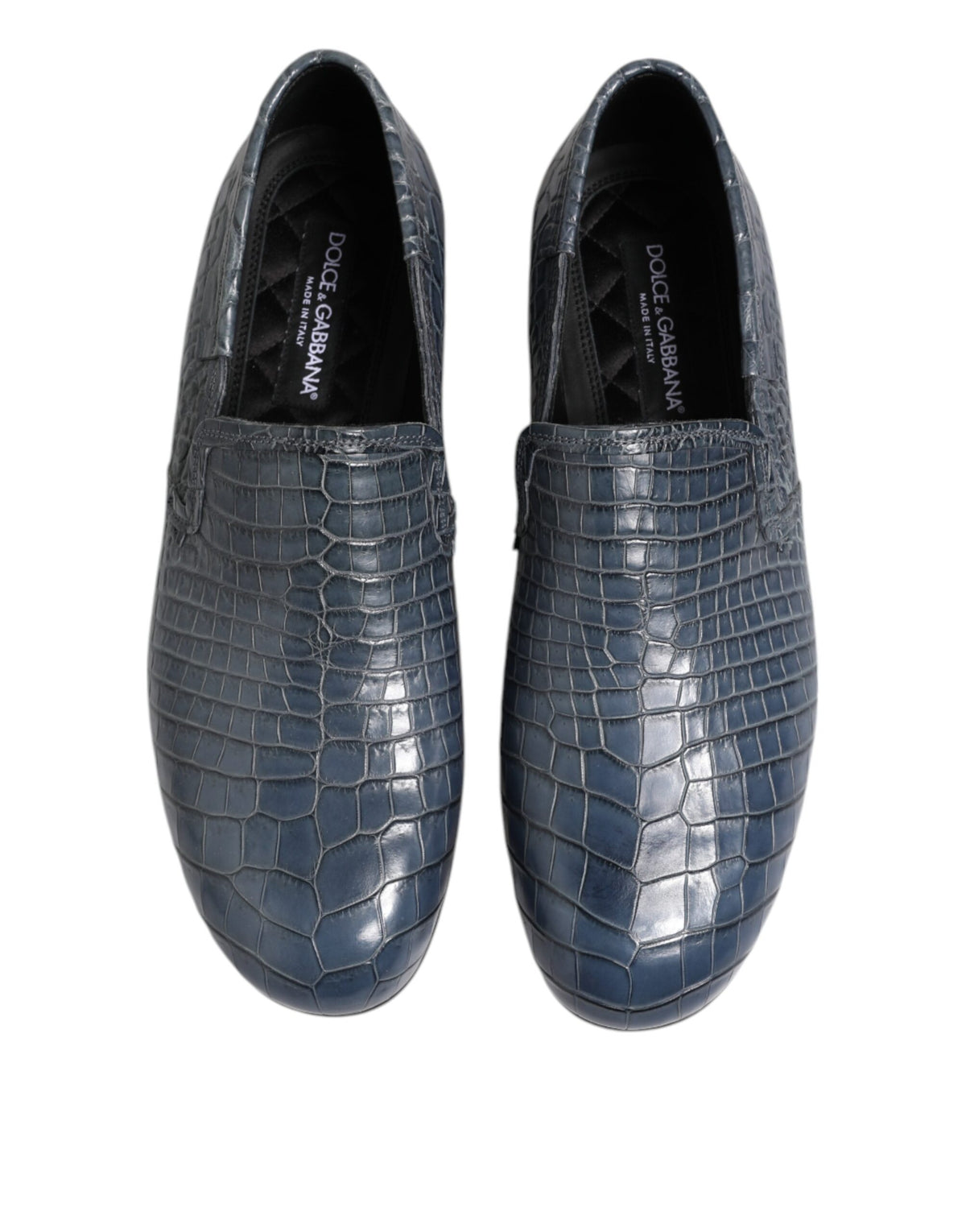 Experience the allure of Dolce & Gabbana's Blue Exotic Leather Slip On Loafers, handcrafted from luxurious crocodile leather, embodying timeless elegance and sophistication.