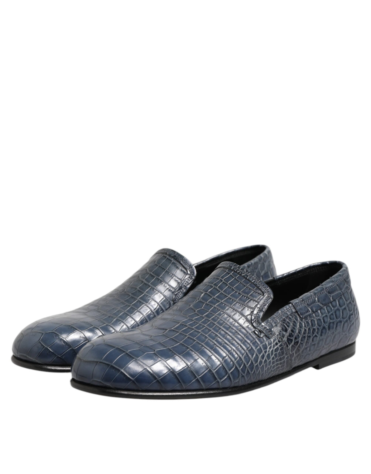Indulge in the exquisite craftsmanship of Dolce & Gabbana's Blue Exotic Leather Slip On Loafers, a luxurious statement piece for the discerning individual.