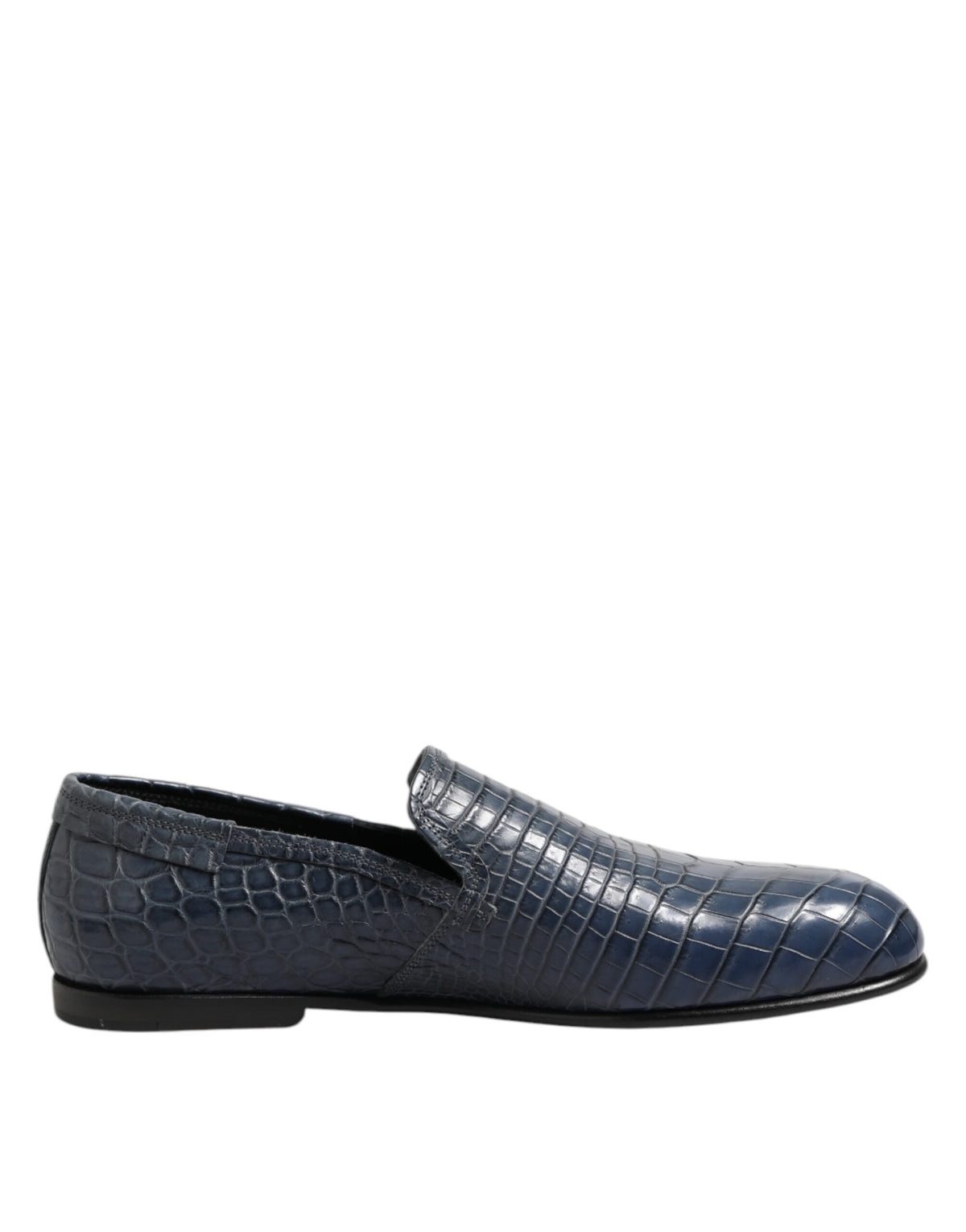 Experience the allure of Dolce & Gabbana's Blue Exotic Leather Slip On Loafers, crafted from luxurious crocodile leather, embodying sophistication and timeless elegance.