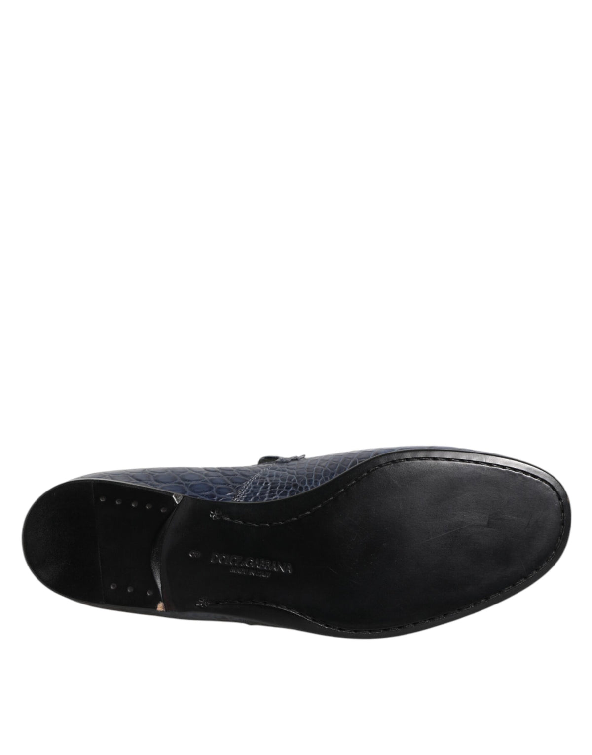 Experience unparalleled elegance with Dolce & Gabbana's Blue Exotic Leather Slip On Loafers, crafted from luxurious crocodile leather for the discerning individual.