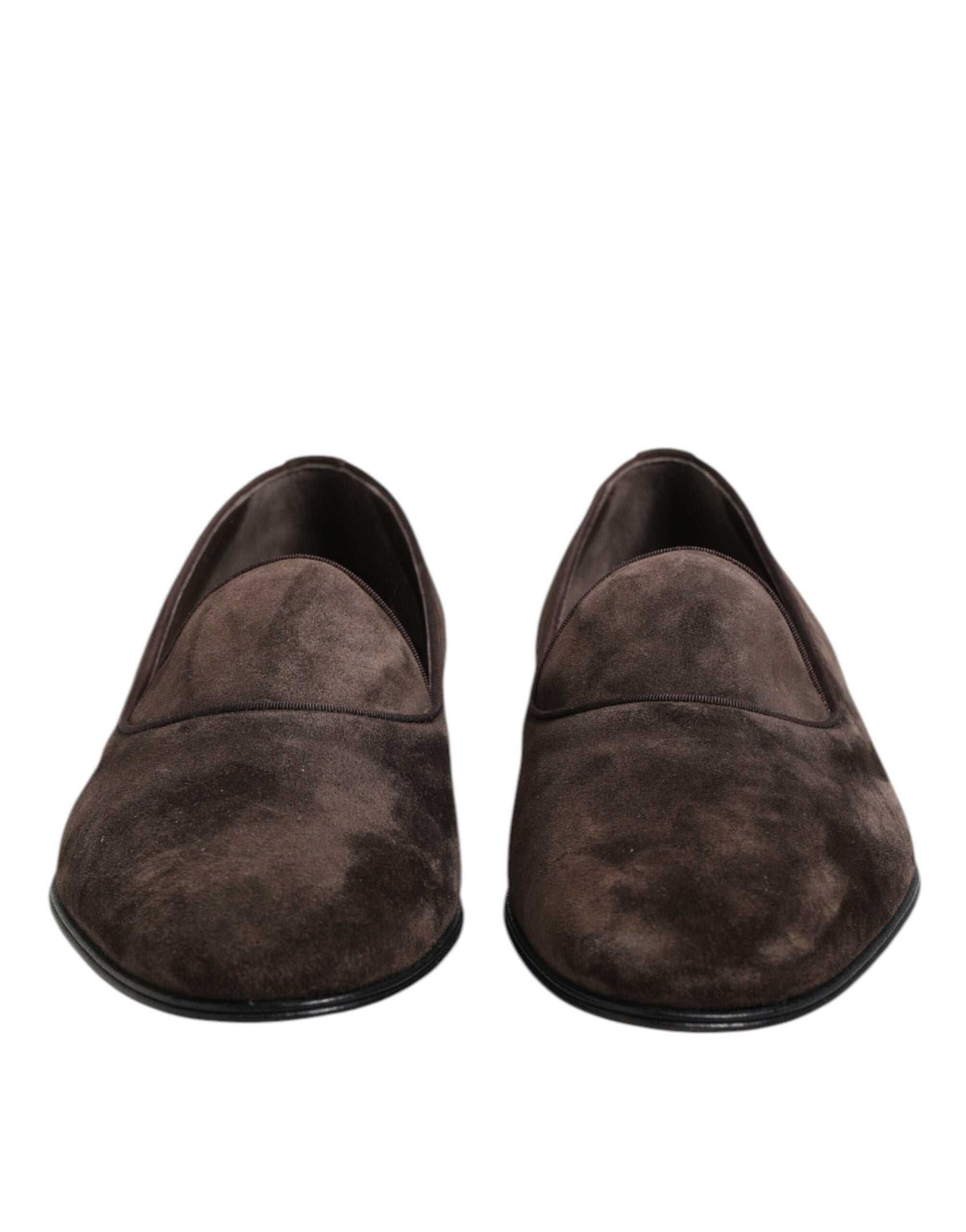 Indulge in the exquisite craftsmanship of Dolce & Gabbana's Brown Velvet Leather Slip On Loafers, a timeless symbol of elegance for the discerning individual.