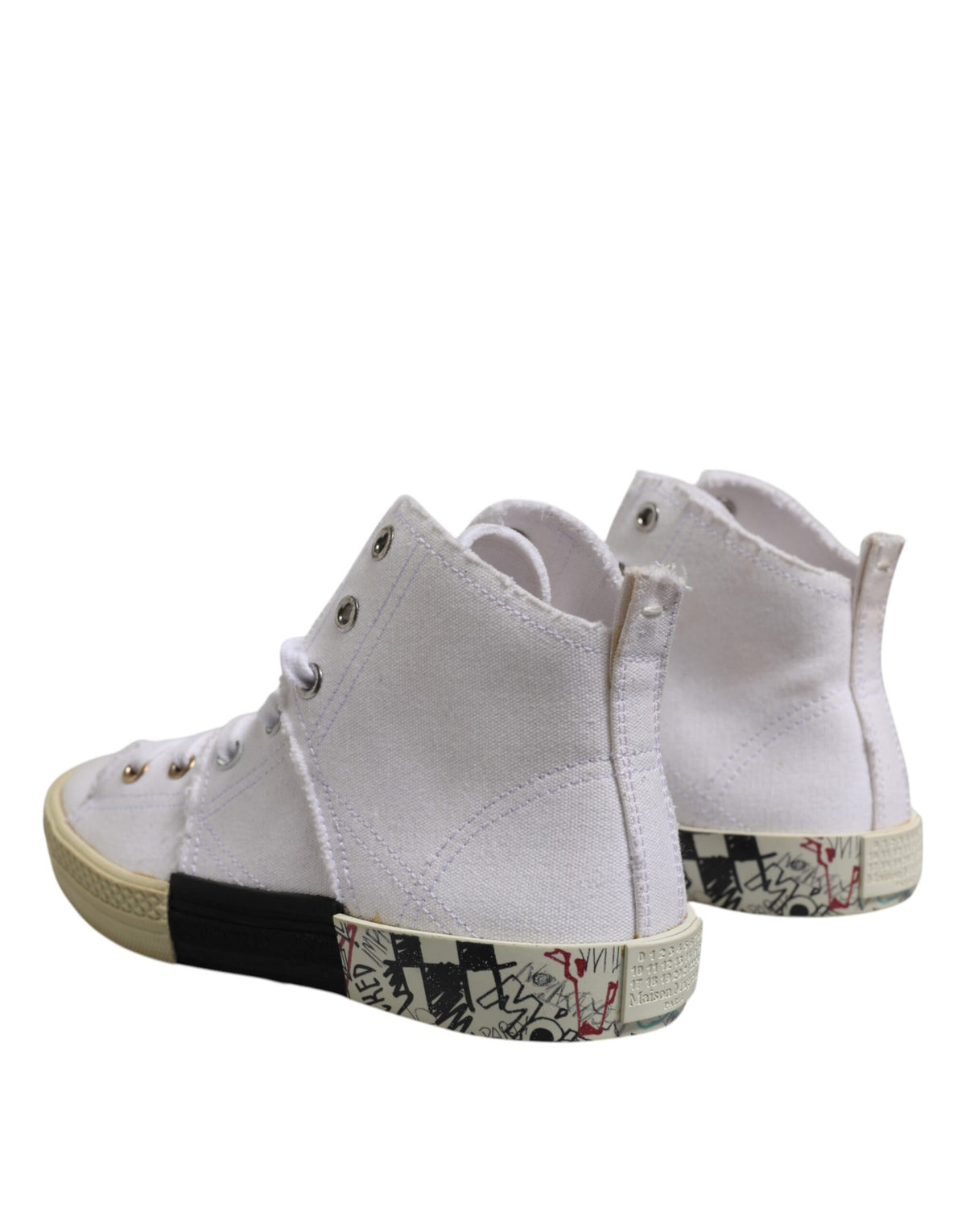 Discover the Maison Margiela White Lace Up Mid Top Sneakers, where premium canvas meets artisanal craftsmanship, embodying luxury for the discerning individual.