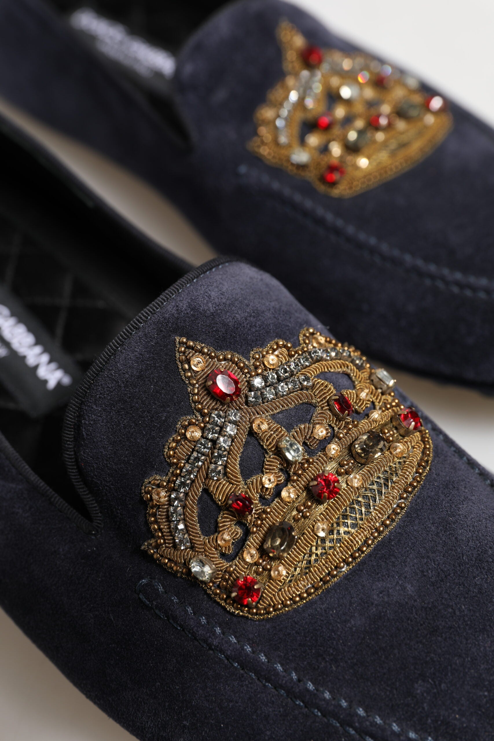 Experience the exquisite allure of Dolce & Gabbana Blue Suede Crown Crystal Loafers, a testament to Italian craftsmanship and luxury that elevates your style narrative.