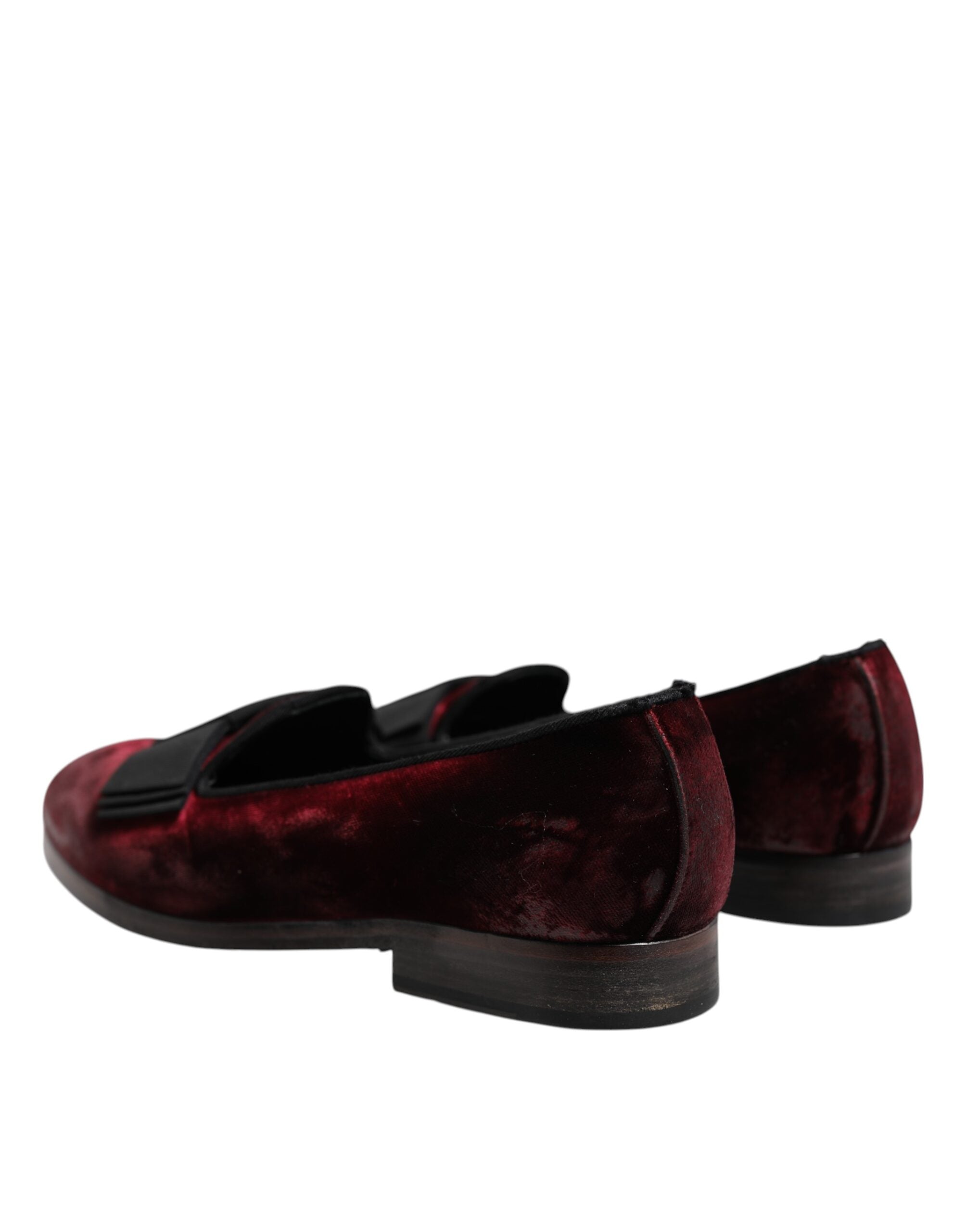 Step into sophistication with Dolce & Gabbana's Red Velvet Slip On Loafers, where luxurious leather meets timeless Italian craftsmanship, perfect for the discerning connoisseur.