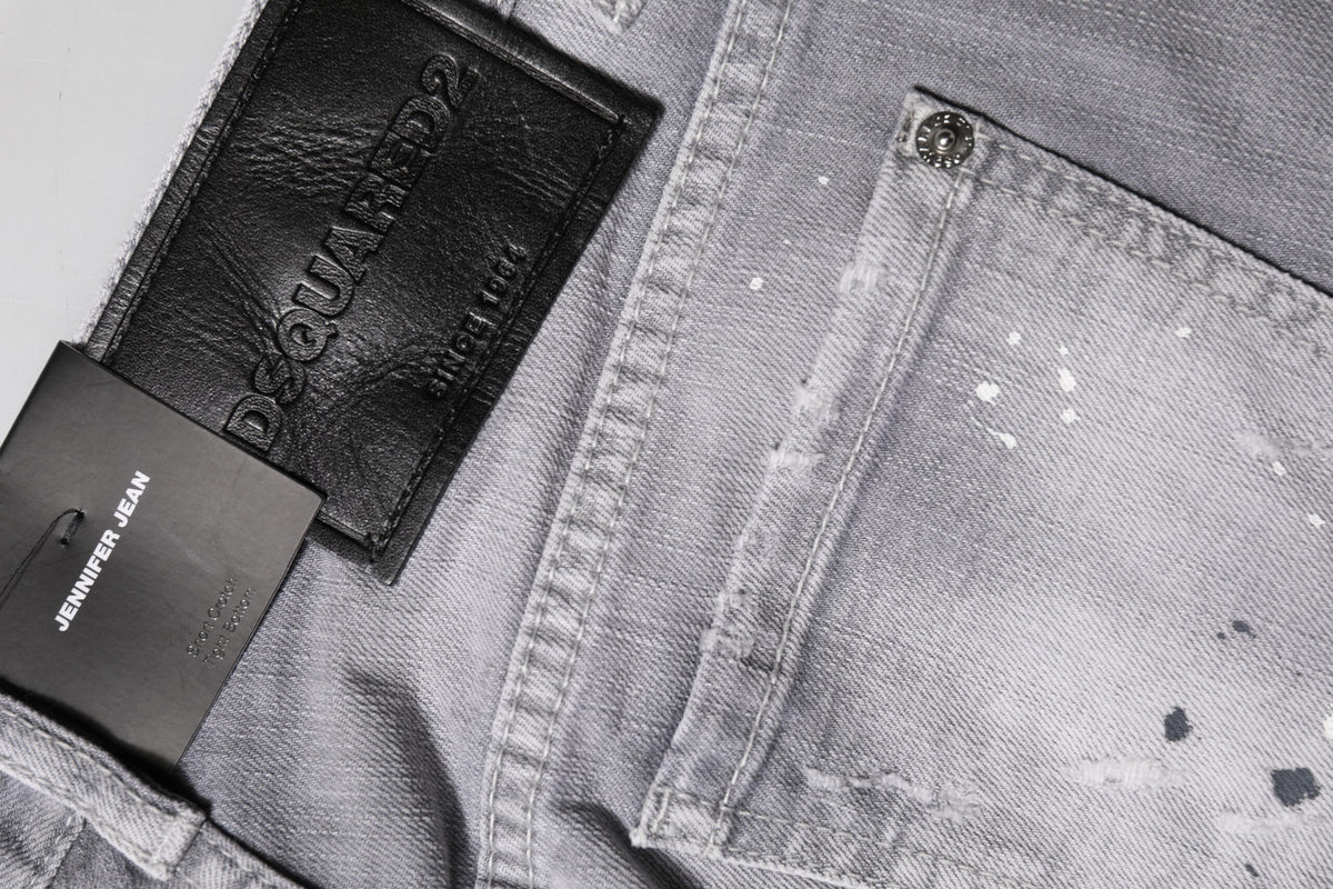 Indulge in the exquisite craftsmanship of Dsquared² Gray Washed Mid Waist Tapered Denim Jeans, where luxurious comfort meets sophisticated allure for the discerning individual.