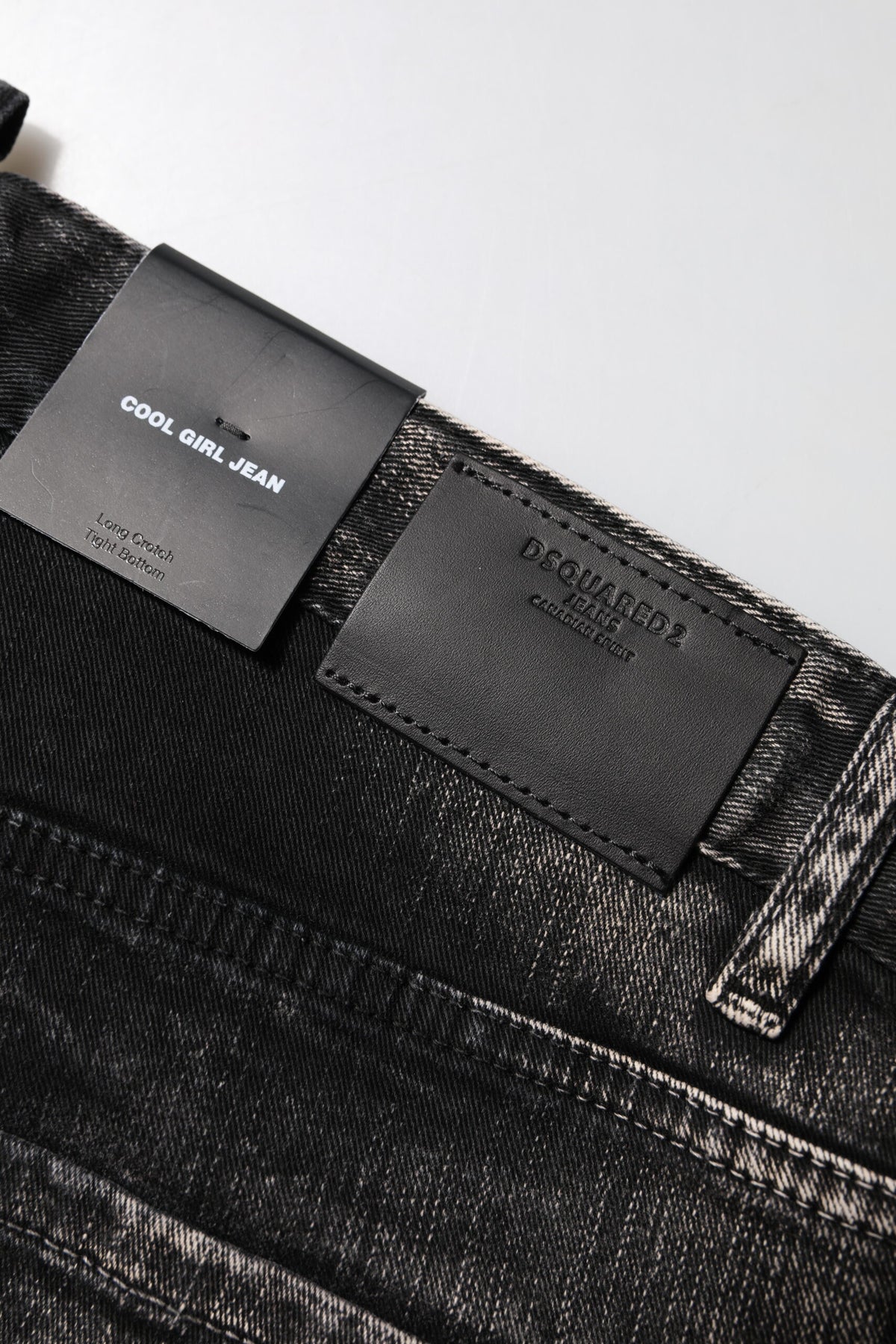 Elevate your style with Dsquared² Black Washed Mid Waist Tapered Denim Jeans, where exquisite craftsmanship meets luxurious comfort, perfect for the discerning individual.
