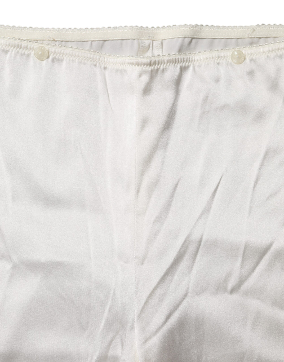 Elevate your wardrobe with Dolce & Gabbana's Ivory Silk Tapered High Waist Pants, a masterpiece of Italian craftsmanship that embodies timeless elegance and sophistication.