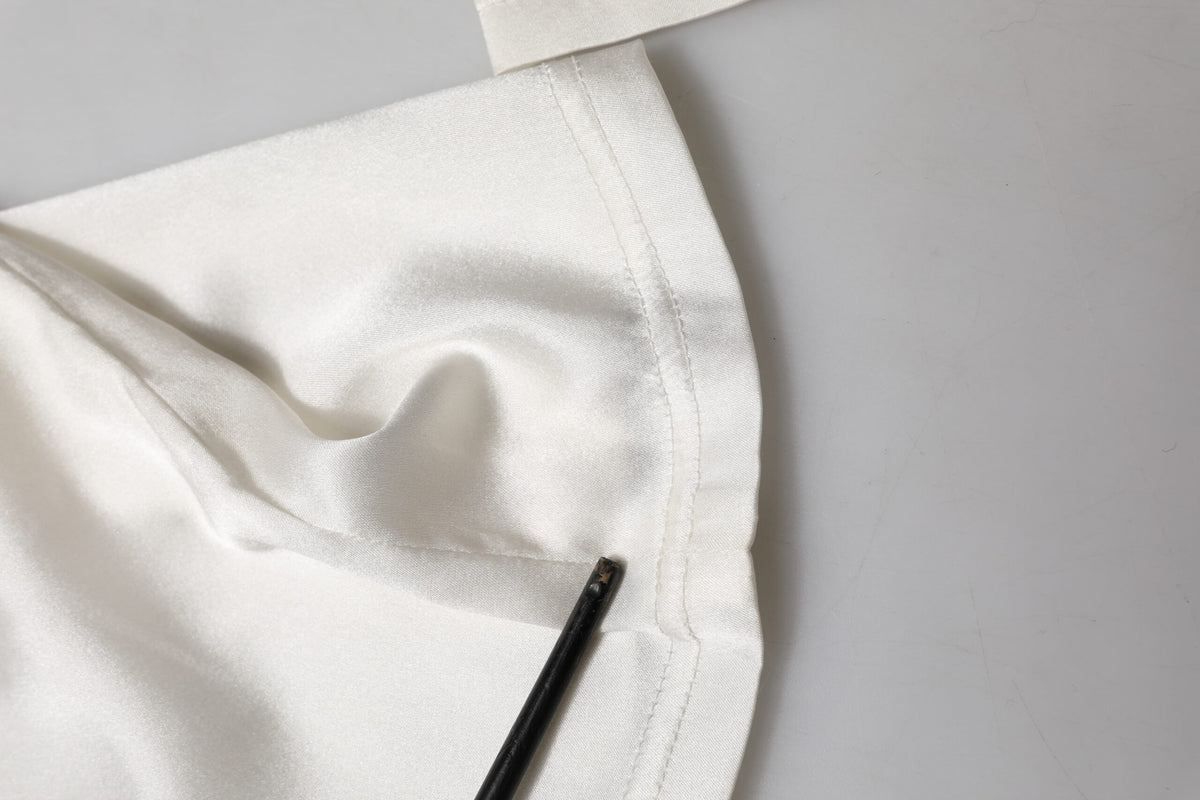 Indulge in the exquisite allure of Dolce & Gabbana's Ivory Silk Tapered High Waist Pants, where luxurious silk meets unparalleled craftsmanship for timeless elegance.