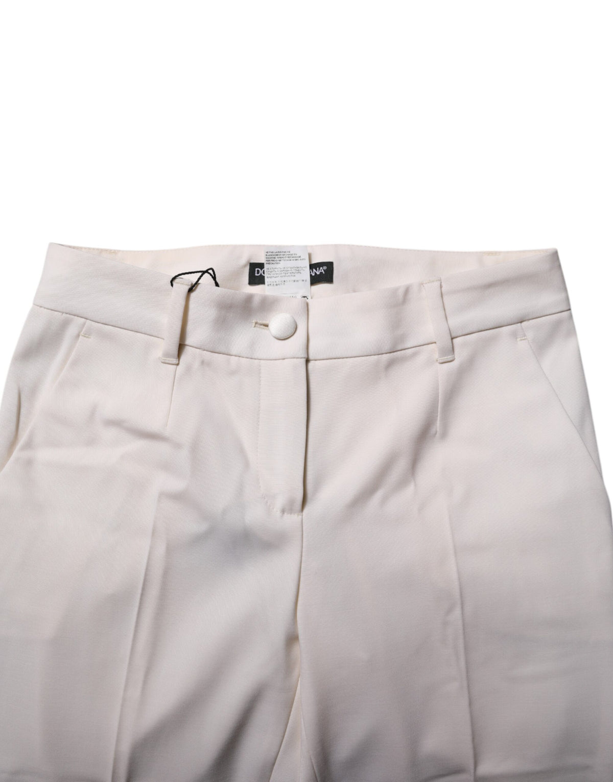 Indulge in the exquisite allure of Dolce & Gabbana's White Wool Tapered High Waist Pants, crafted from luxurious virgin wool for a silhouette that embodies elegance and sophistication.