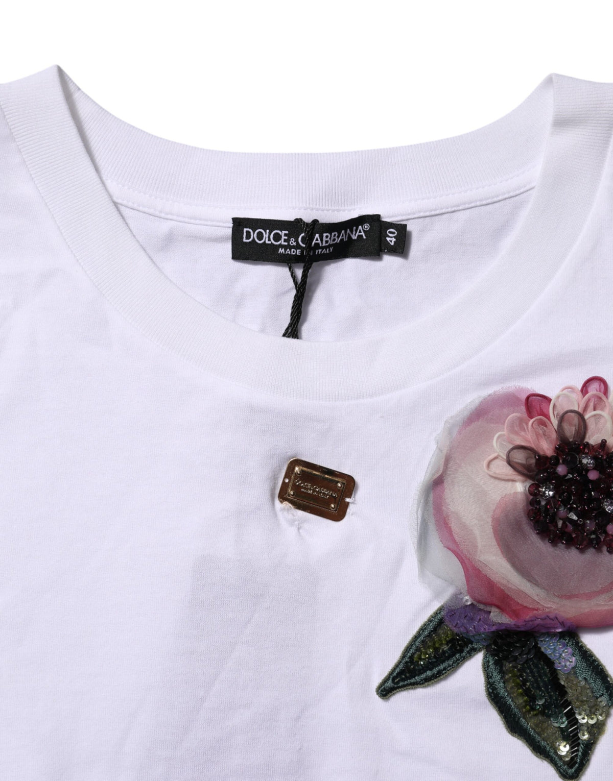 Indulge in the exquisite Dolce & Gabbana White Floral Lace Cropped T-shirt, crafted from 100% cotton, embodying luxury and elegance for the discerning fashion connoisseur.
