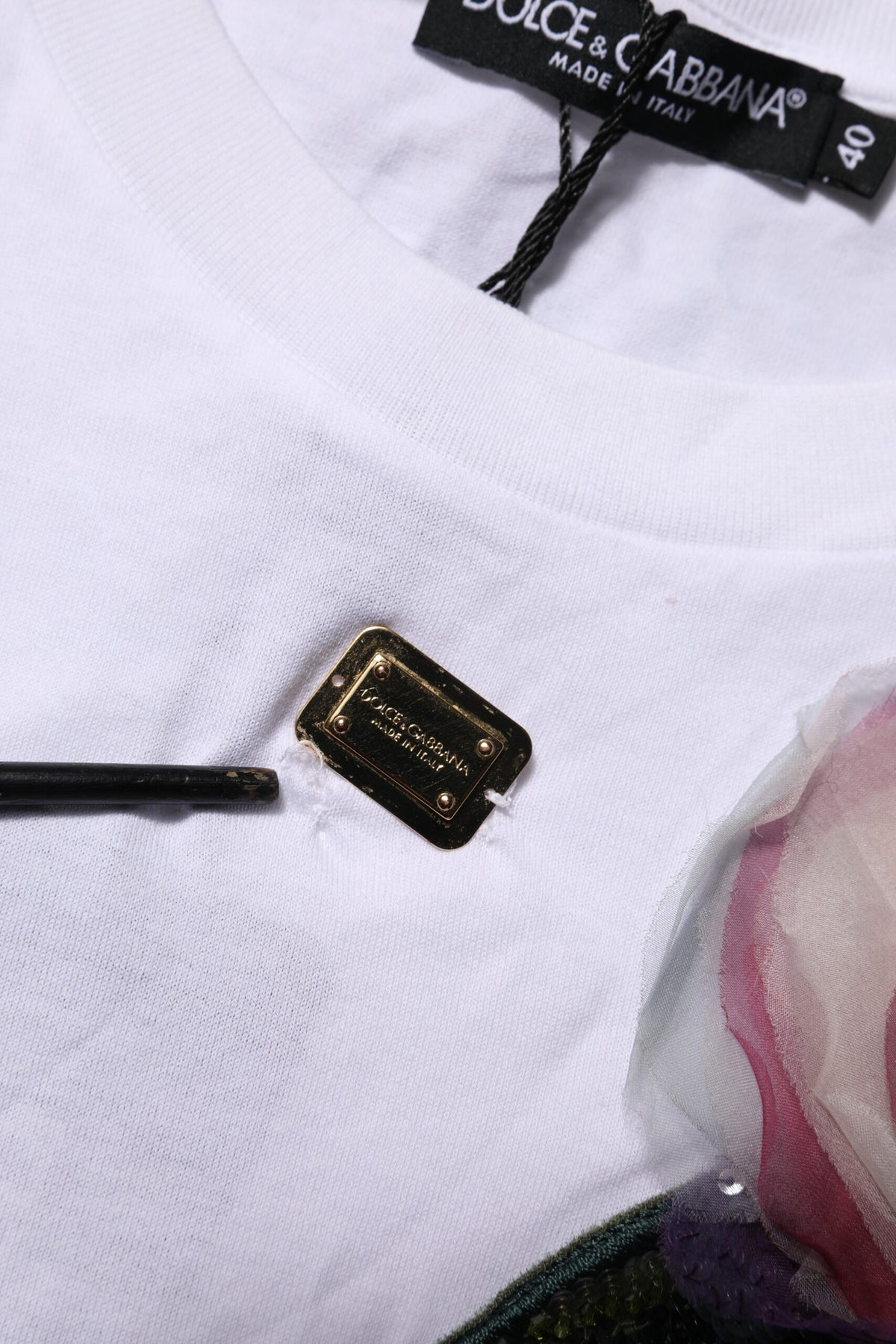 Indulge in the exquisite allure of Dolce & Gabbana's White Floral Lace Cropped T-shirt, crafted from luxurious cotton in Italy, embodying timeless elegance and sophisticated style.