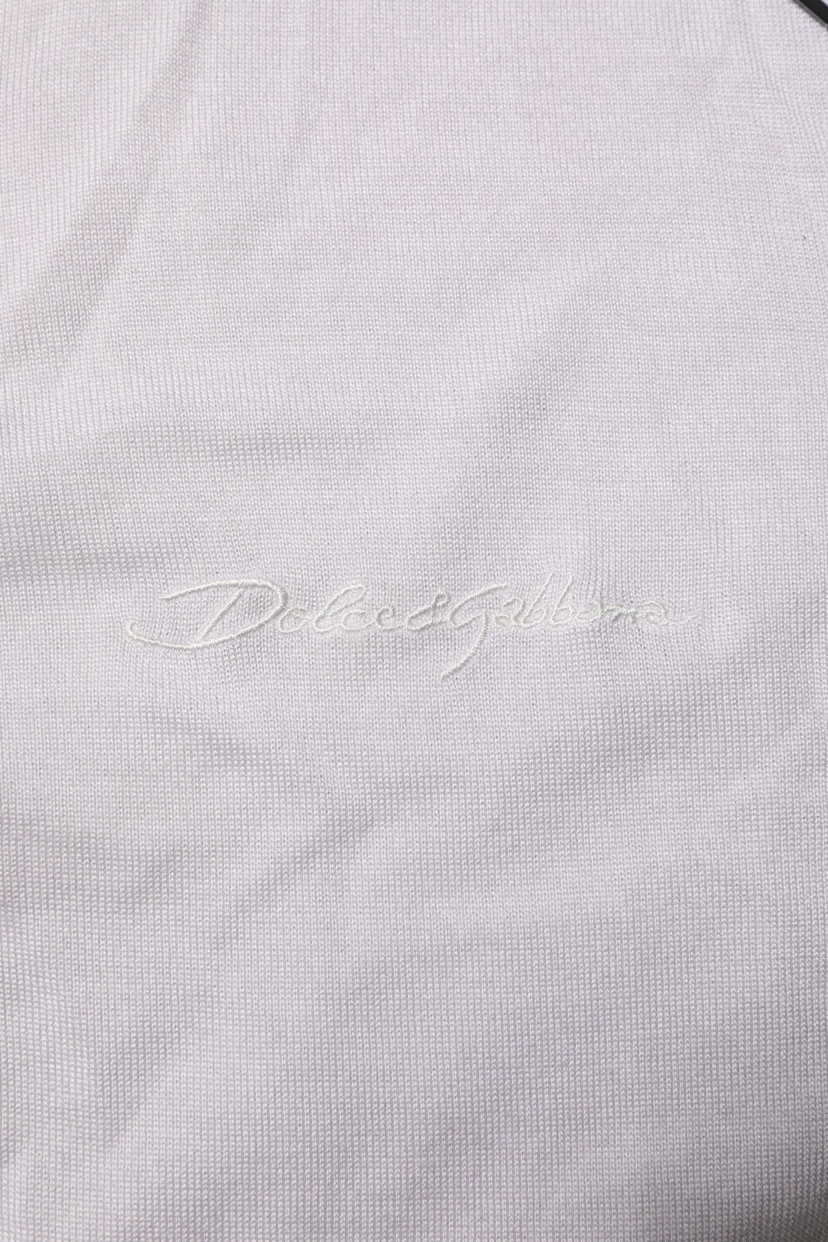 Indulge in the exquisite Dolce & Gabbana White Silk Henley T-shirt, a masterpiece of Italian craftsmanship that embodies timeless elegance and luxurious comfort.