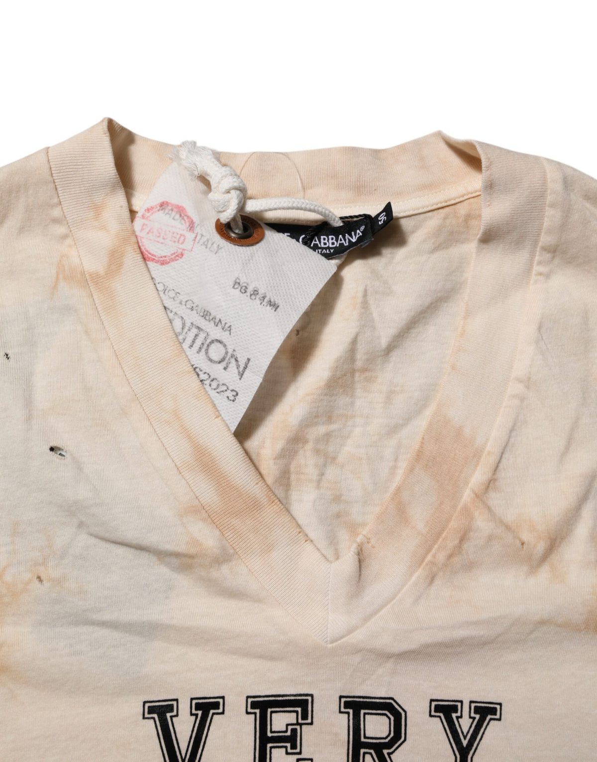 Elevate your wardrobe with the Dolce & Gabbana Beige Logo Print Short Sleeve V-neck T-shirt, a luxurious 100% cotton staple that embodies timeless elegance and Italian craftsmanship.