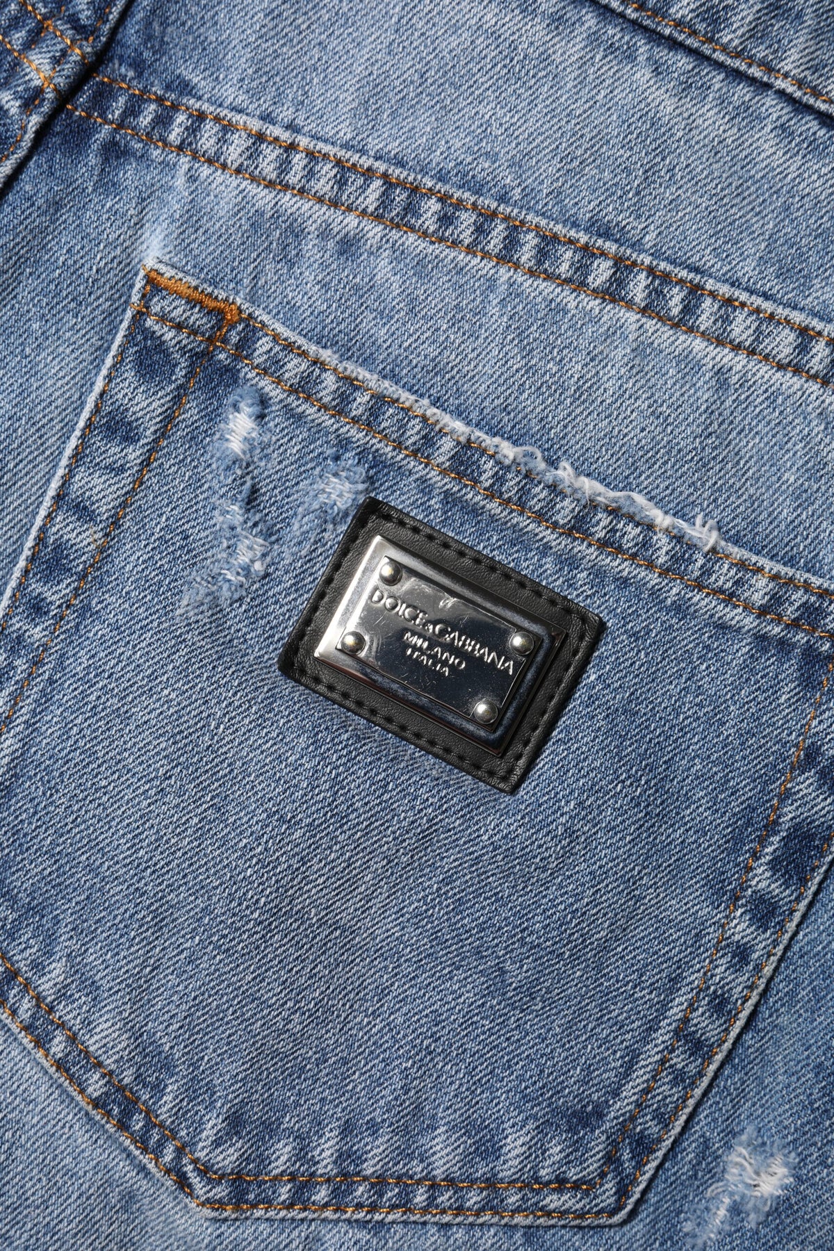 Elevate your wardrobe with Dolce & Gabbana's Blue Logo Plaque Denim Hot Pants, a luxurious blend of Italian craftsmanship and modern elegance, perfect for any sophisticated occasion.