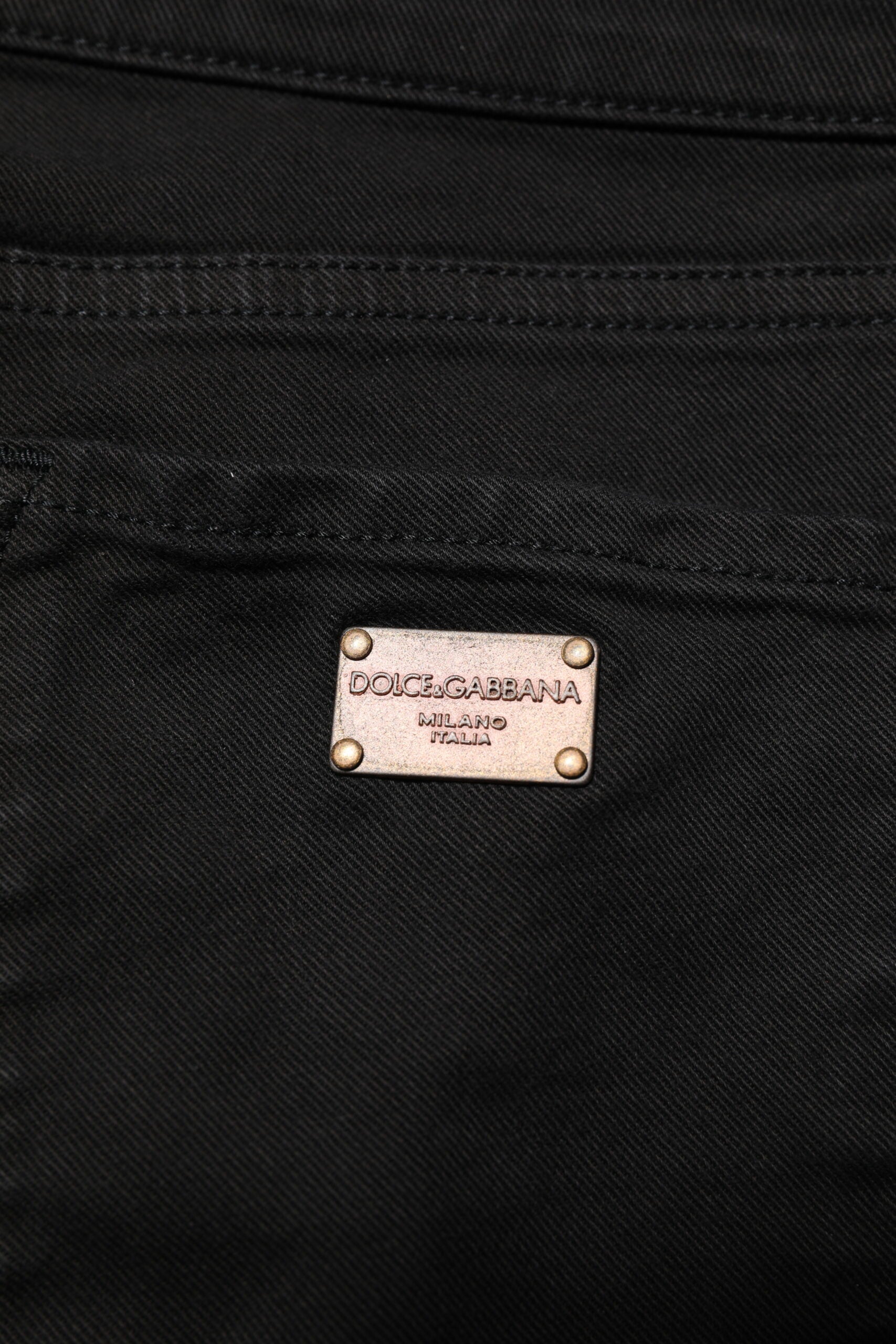 Experience the epitome of luxury with Dolce & Gabbana's Black Cotton Logo Skinny Mid Waist Denim Jeans, crafted in Italy for unparalleled elegance and sophistication.