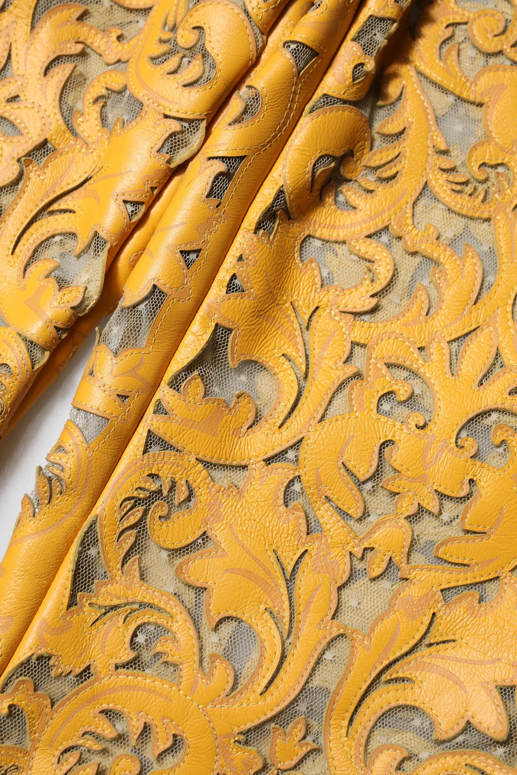 Indulge in the exquisite Dolce & Gabbana Yellow Floral Lace Mid Waist Capri Pants, crafted from premium bull leather, embodying luxury and sophistication for every occasion.