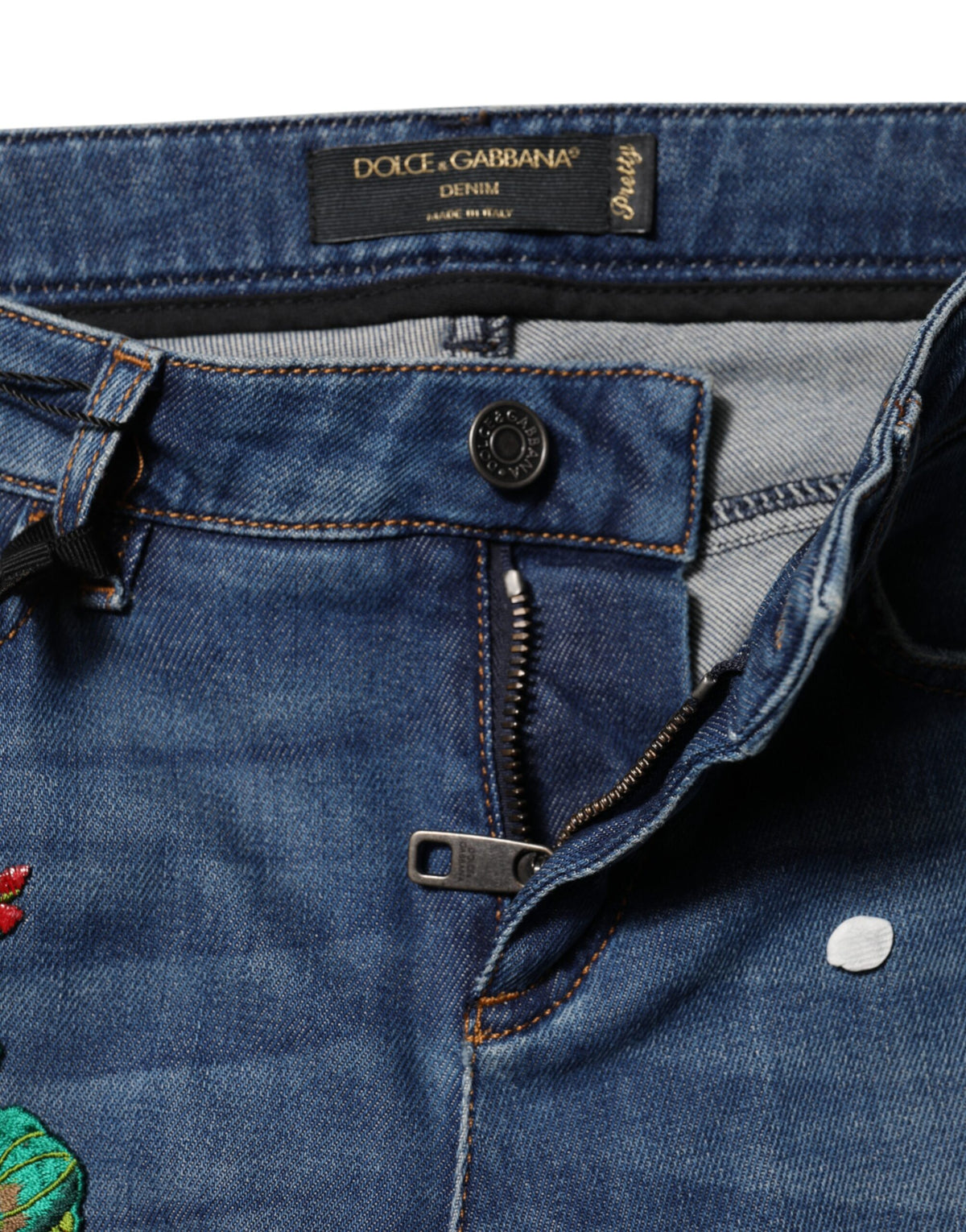 Indulge in the artistry of Dolce & Gabbana's Blue Cotton Mid Waist Skinny Denim Jeans, where exquisite floral embroidery meets Italian craftsmanship for a timeless, elegant silhouette.