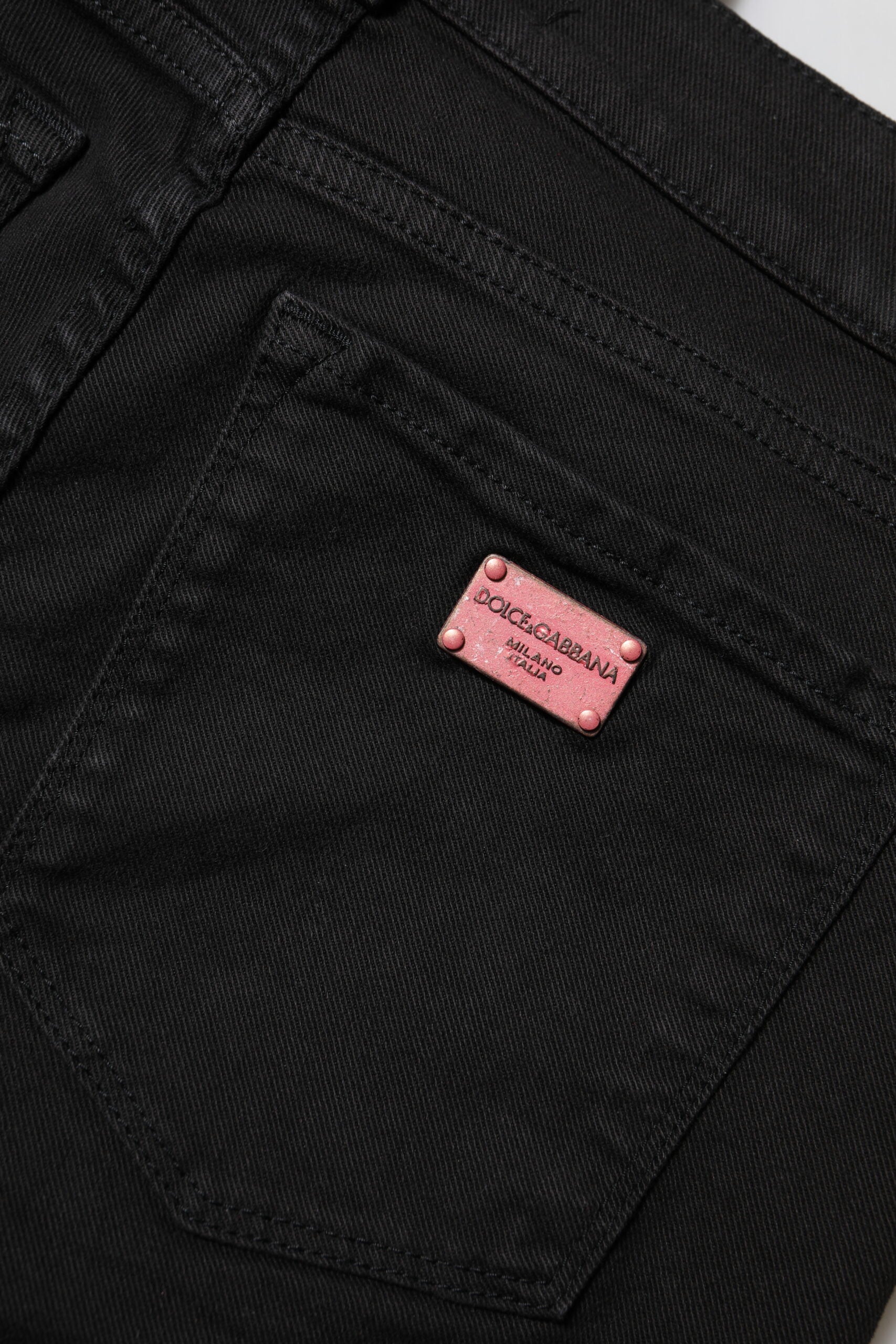Indulge in the allure of Dolce & Gabbana's Black Cotton Skinny Mid Waist Denim Jeans, where exquisite Italian craftsmanship meets timeless elegance for the discerning individual.
