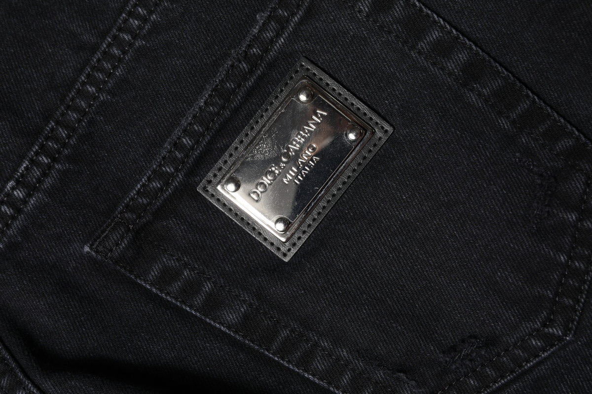 Indulge in the exquisite Dolce & Gabbana Black Cotton Tattered Mid Waist Denim Jeans, where luxurious craftsmanship meets rebellious elegance for the modern connoisseur.