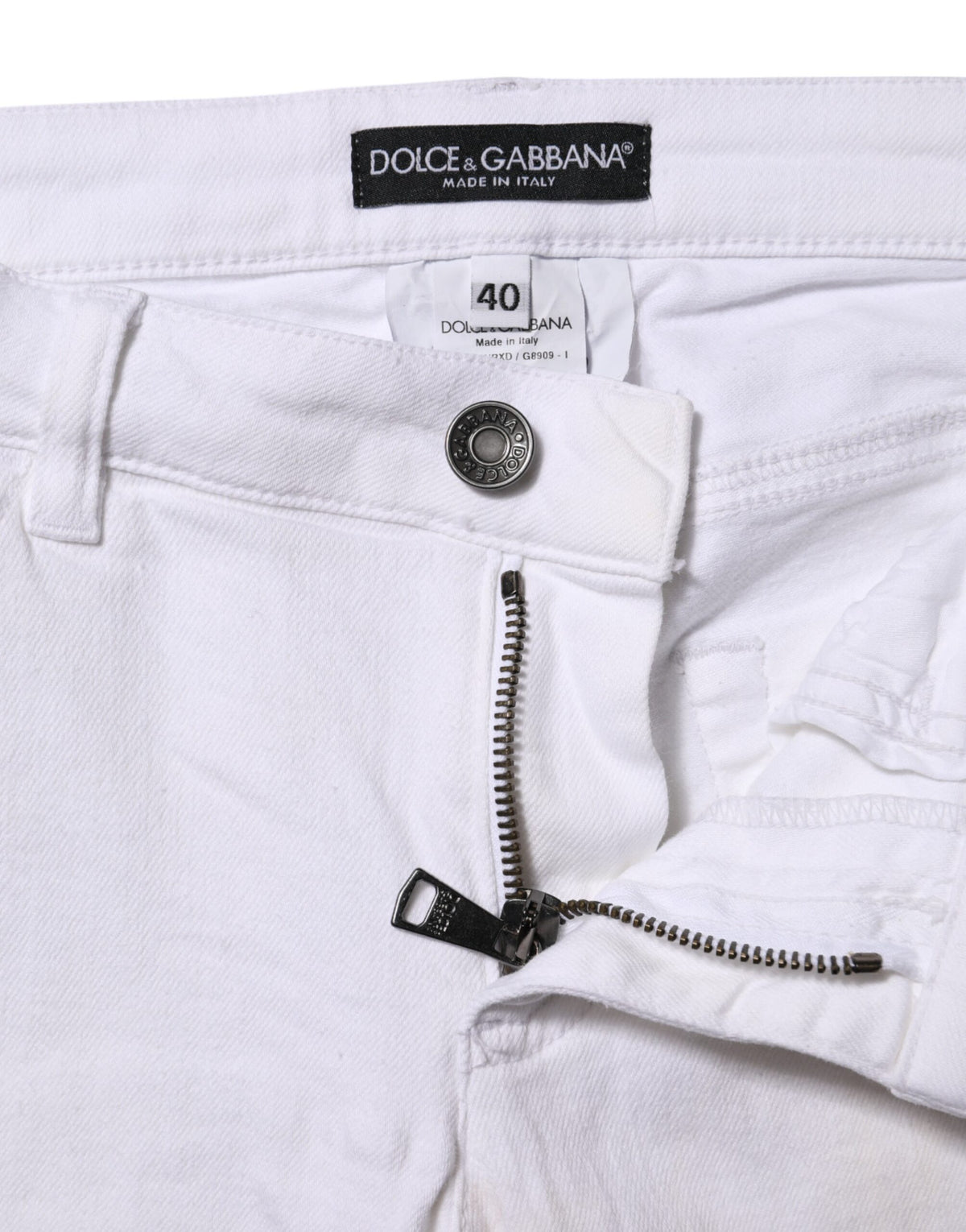 Experience the allure of Dolce & Gabbana's White Cotton Low Waist Skinny Denim Jeans, where exquisite craftsmanship meets timeless elegance, perfect for the discerning individual.