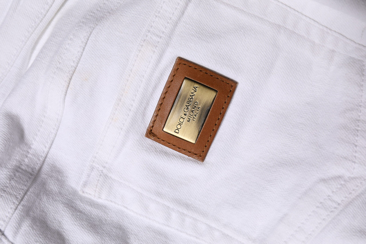 Elevate your wardrobe with Dolce & Gabbana's White Cotton Low Waist Skinny Denim Jeans, a luxurious blend of comfort and sophistication, crafted for the discerning individual.