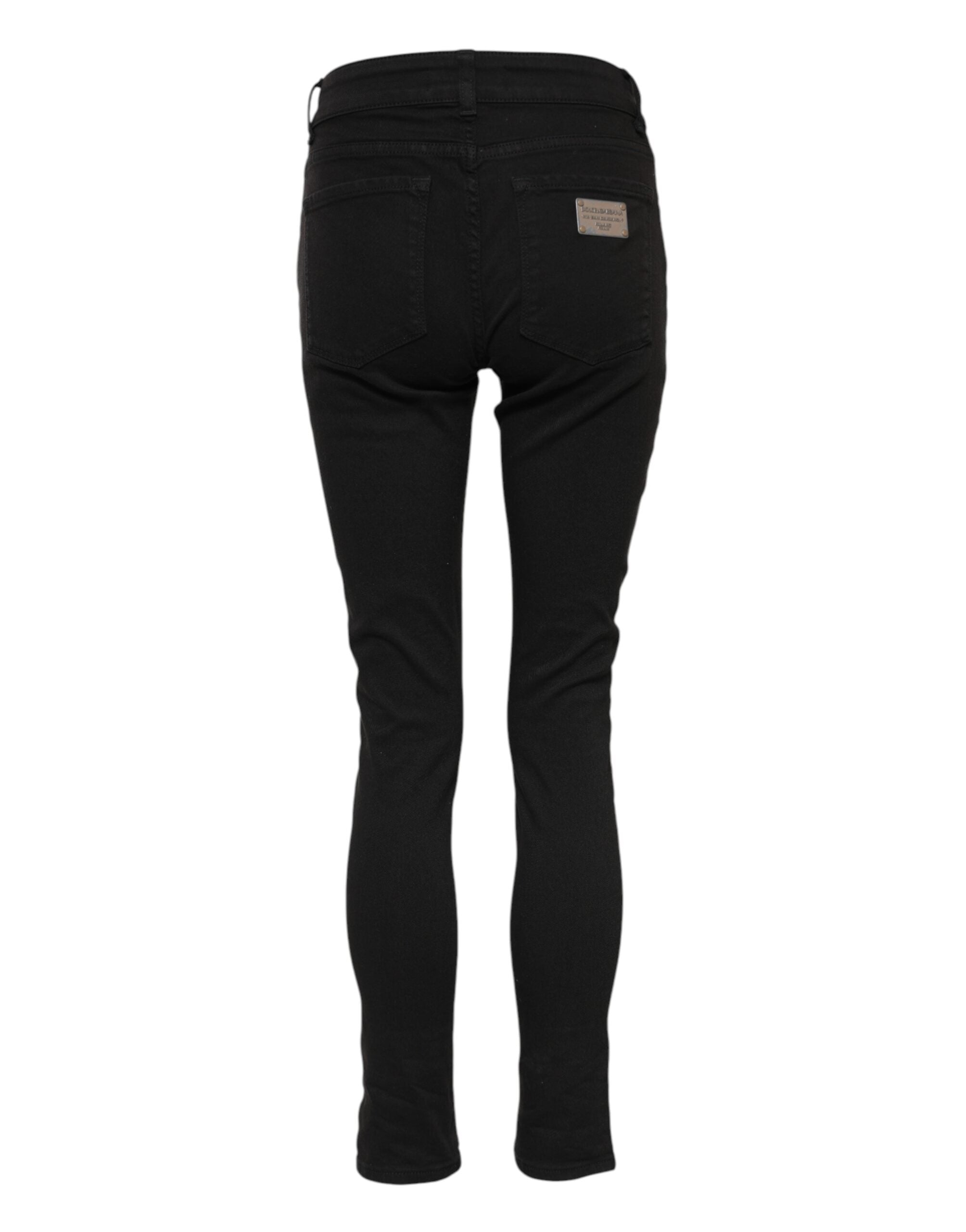 Indulge in the exquisite luxury of Dolce & Gabbana's black cotton logo skinny mid waist jeans, where timeless craftsmanship meets elegant style for the discerning individual.
