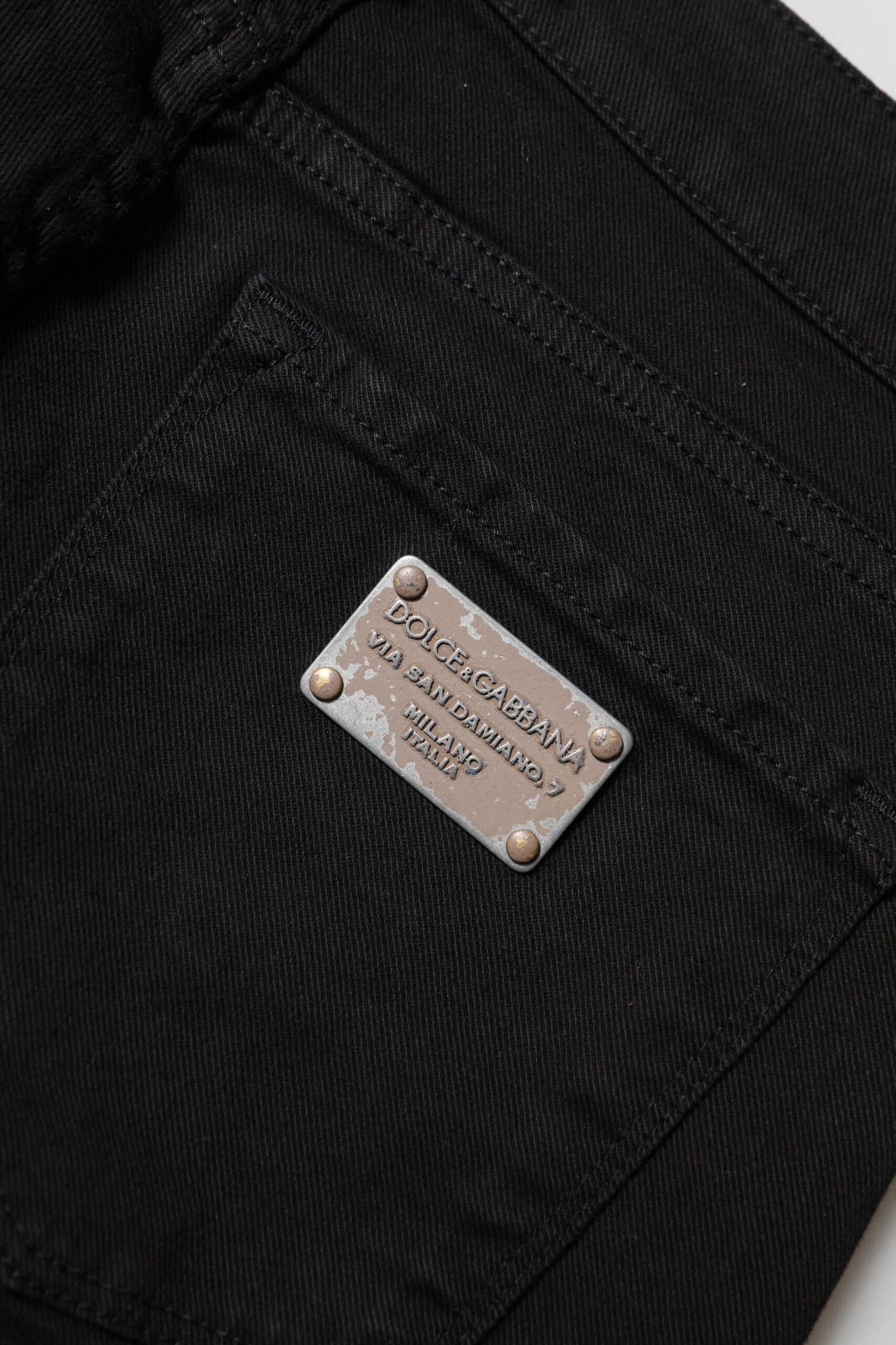 Indulge in the exquisite allure of Dolce & Gabbana's black cotton logo skinny mid waist jeans, where timeless luxury meets unparalleled craftsmanship for a sophisticated wardrobe essential.