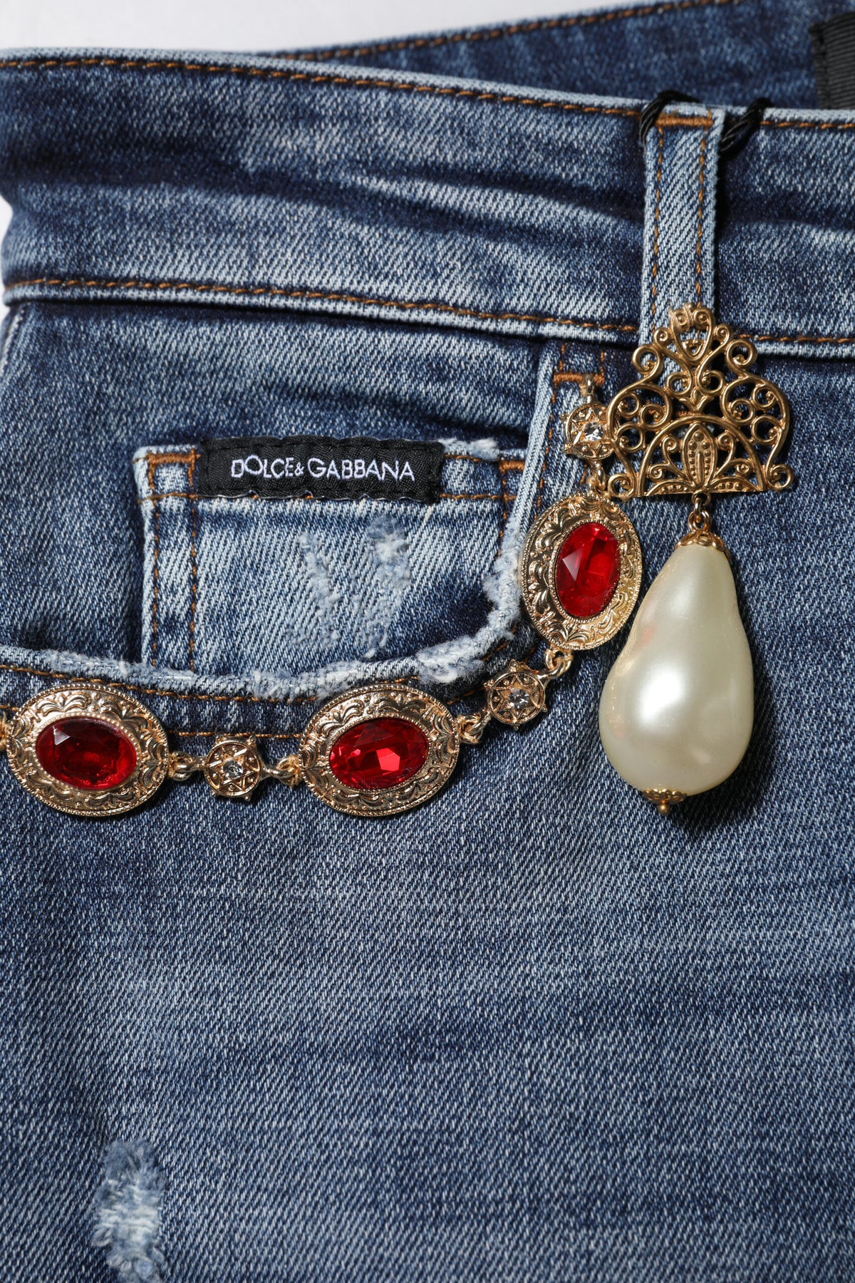 Indulge in the exquisite craftsmanship of Dolce & Gabbana's Blue Rhinestone Embellished Denim Jeans, where luxurious elegance meets effortless style for the discerning individual.