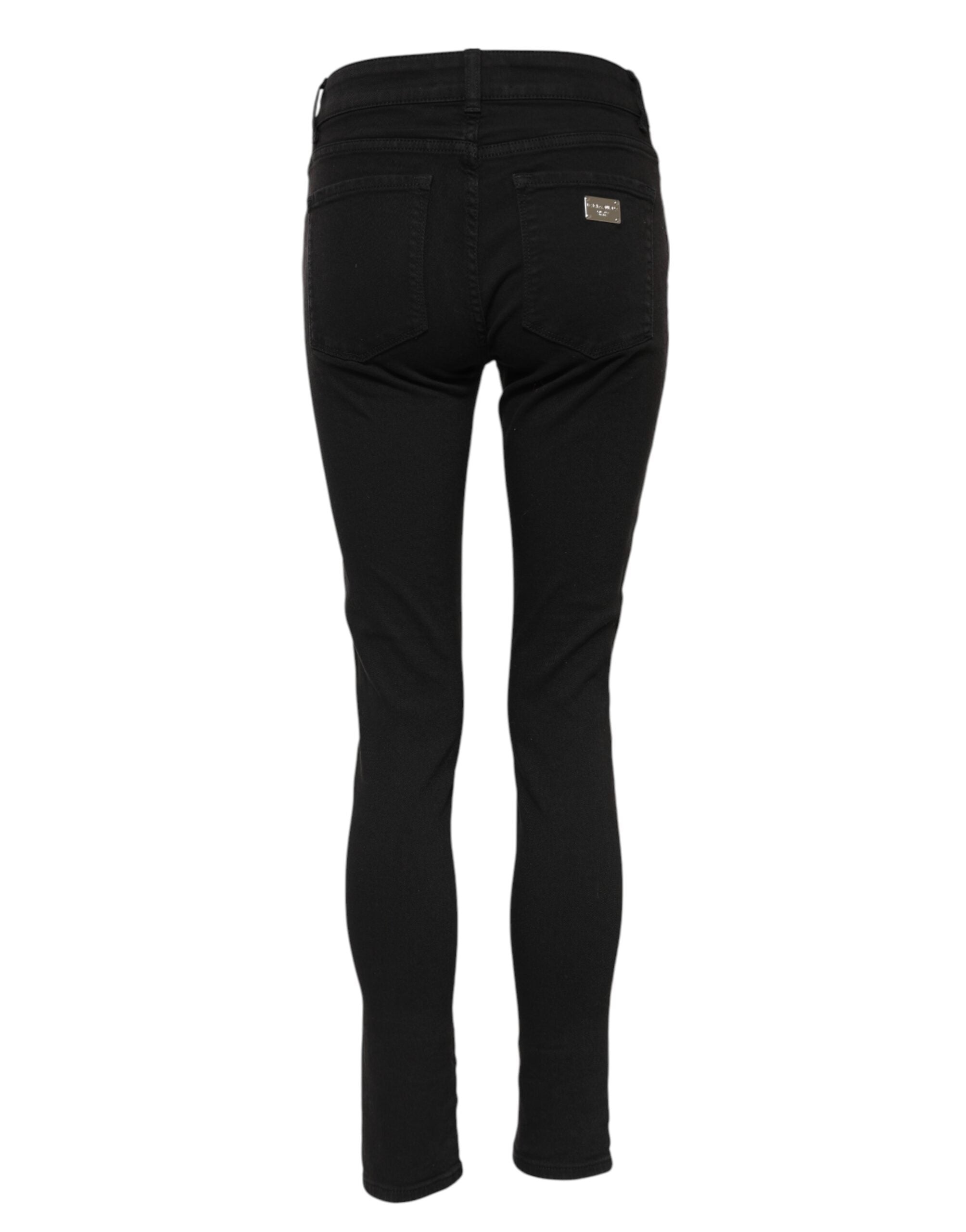 Indulge in the elegance of Dolce & Gabbana's Black Cotton Logo Skinny Mid Waist Denim Jeans, a testament to Italian craftsmanship that elevates your wardrobe with timeless luxury.