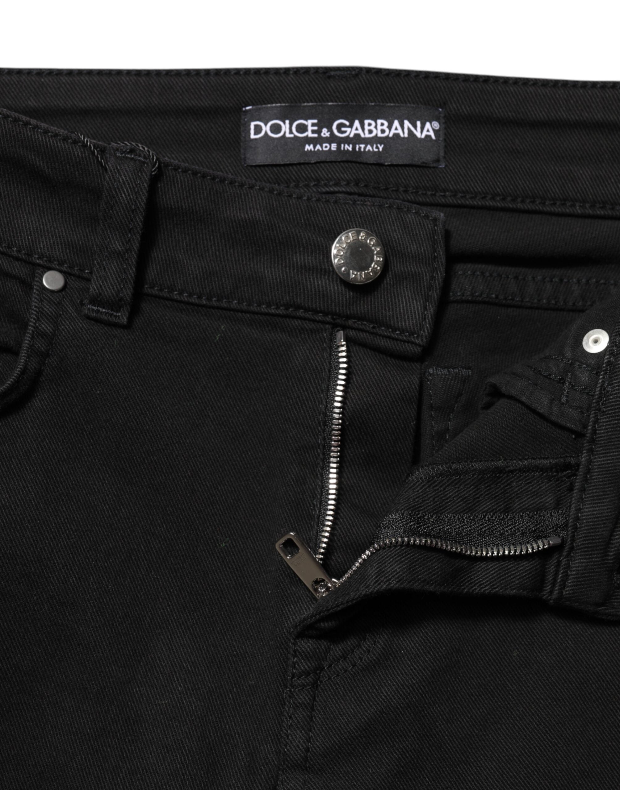 Indulge in the exquisite luxury of Dolce & Gabbana's Black Cotton Logo Skinny Mid Waist Denim Jeans, where Italian craftsmanship meets timeless elegance for the discerning fashion connoisseur.