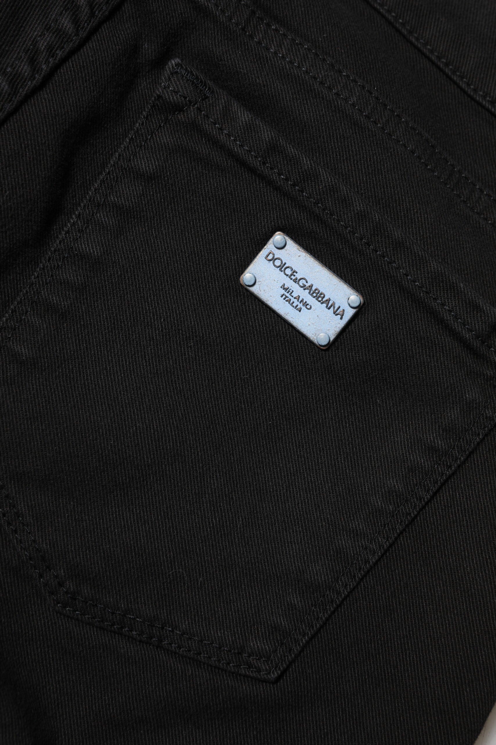 Indulge in the exquisite allure of Dolce & Gabbana's Black Cotton Logo Skinny Mid Waist Denim Jeans, where Italian craftsmanship meets timeless elegance for the discerning fashion lover.
