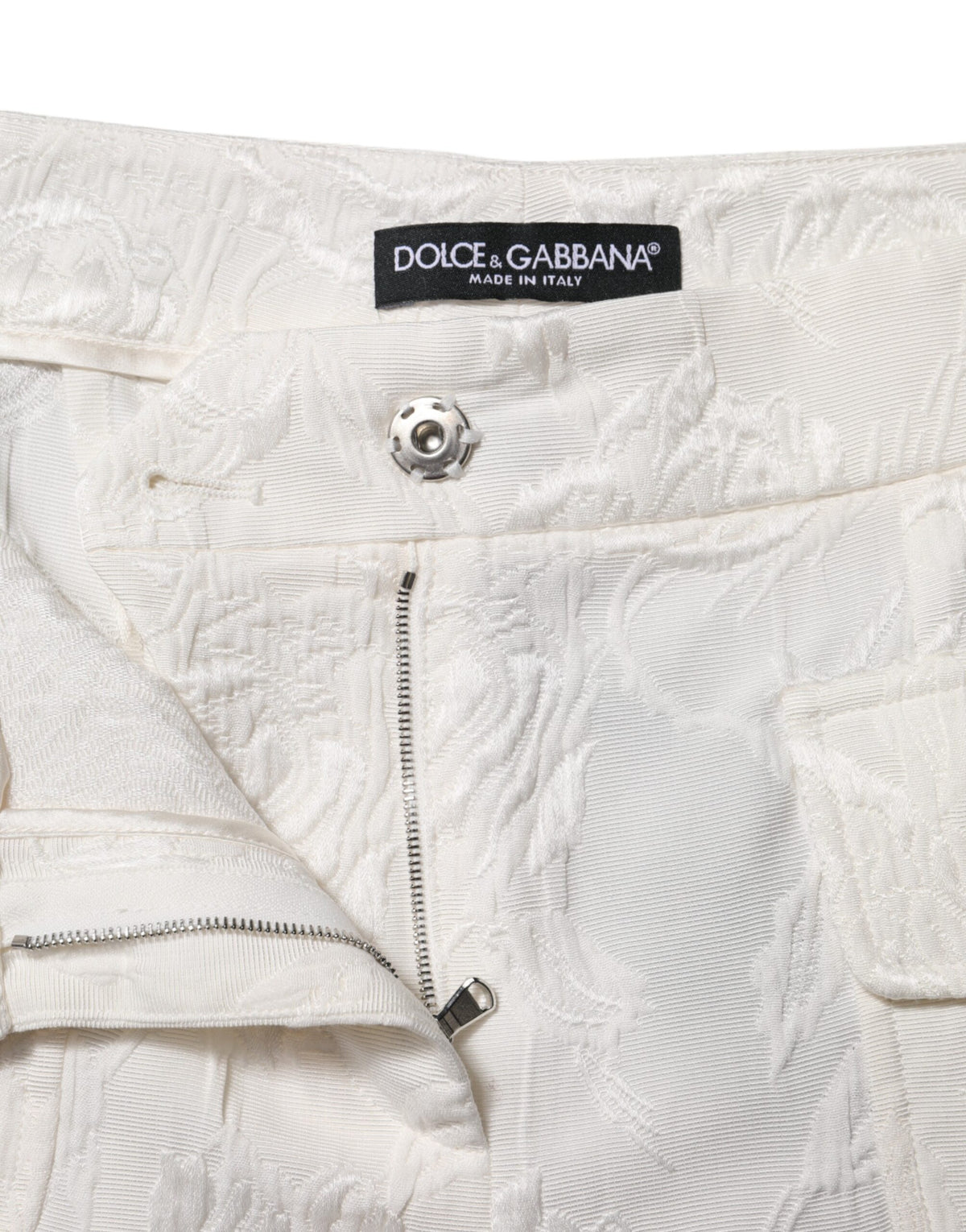 Indulge in the exquisite allure of Dolce & Gabbana's White Cotton Floral Jacquard Pants, where luxurious craftsmanship meets timeless elegance for the discerning individual.