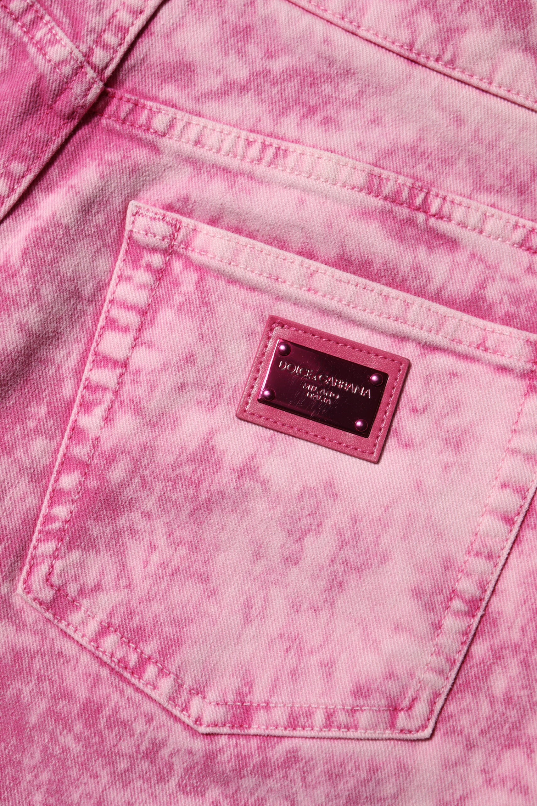 Indulge in the exquisite craftsmanship of Dolce & Gabbana's Pink Tie Dye High Waist Tapered Denim Jeans, where luxury meets contemporary Italian design for the discerning individual.