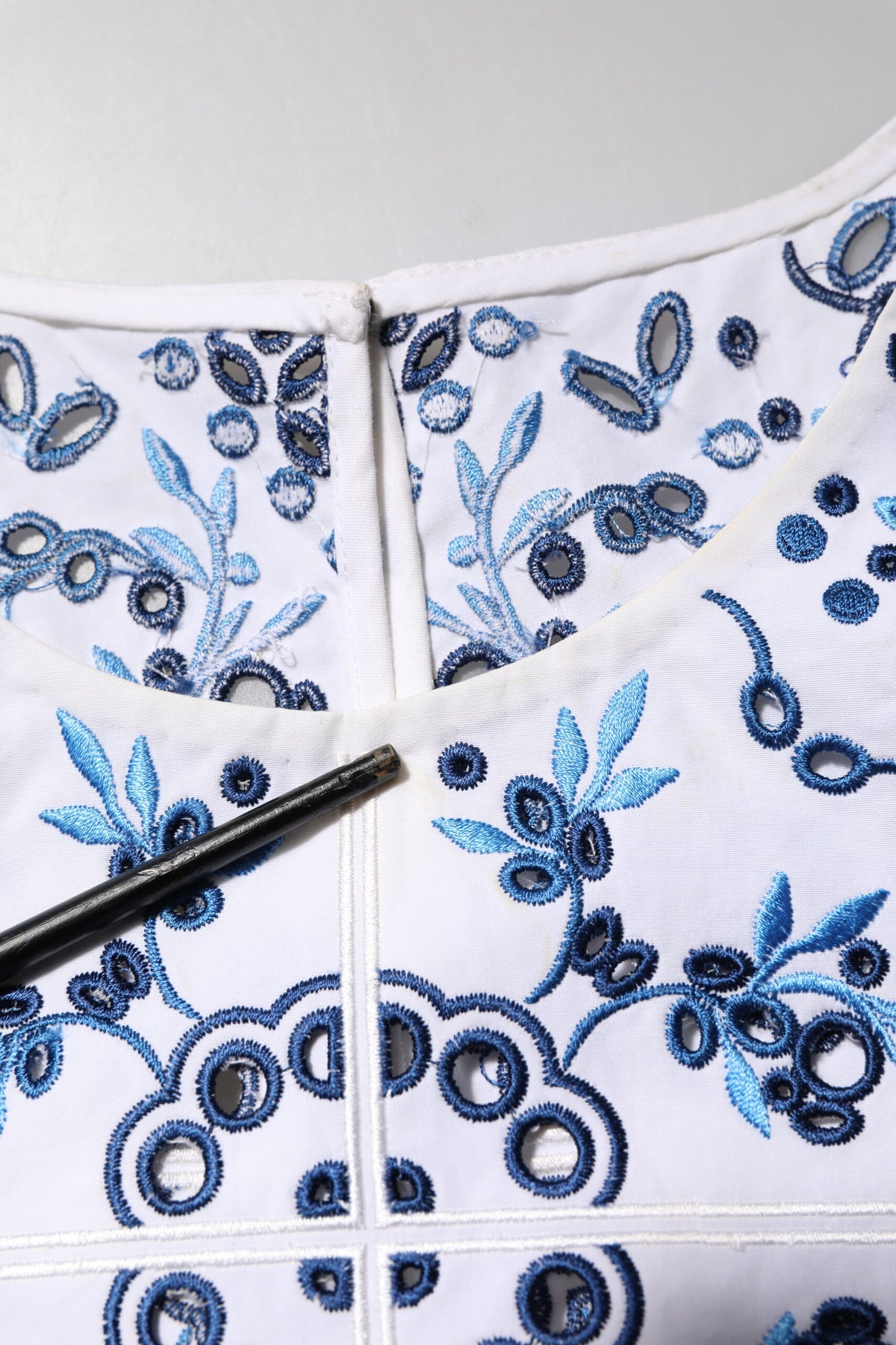 Elevate your wardrobe with the Dolce & Gabbana Blue Lace Eyelet Crew Neck Blouse, a masterpiece of Italian craftsmanship blending luxury and timeless elegance.