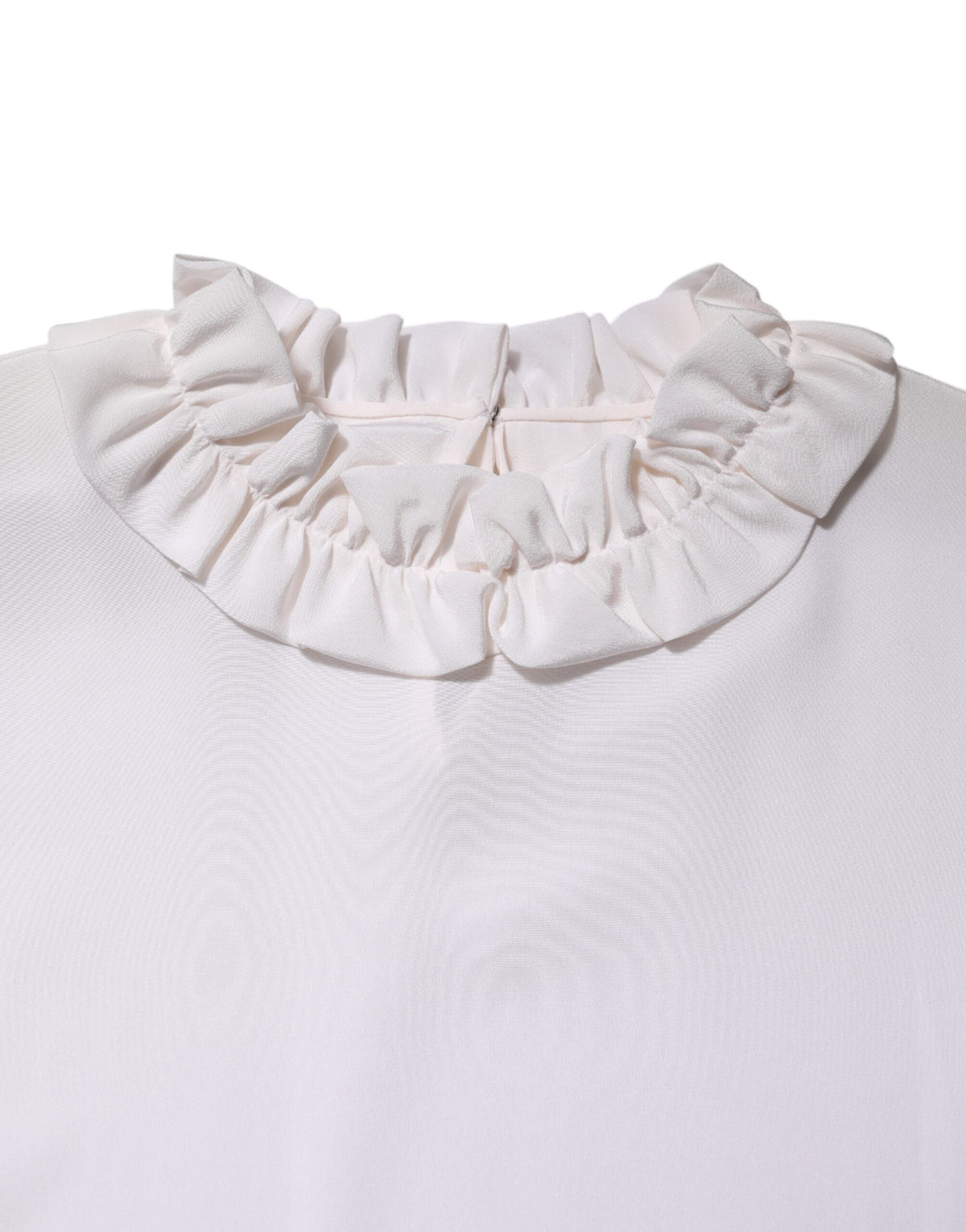 Elevate your wardrobe with the Dolce & Gabbana White Ruffled Neckline Blouse, a silk masterpiece that embodies timeless elegance and exquisite craftsmanship for the discerning individual.
