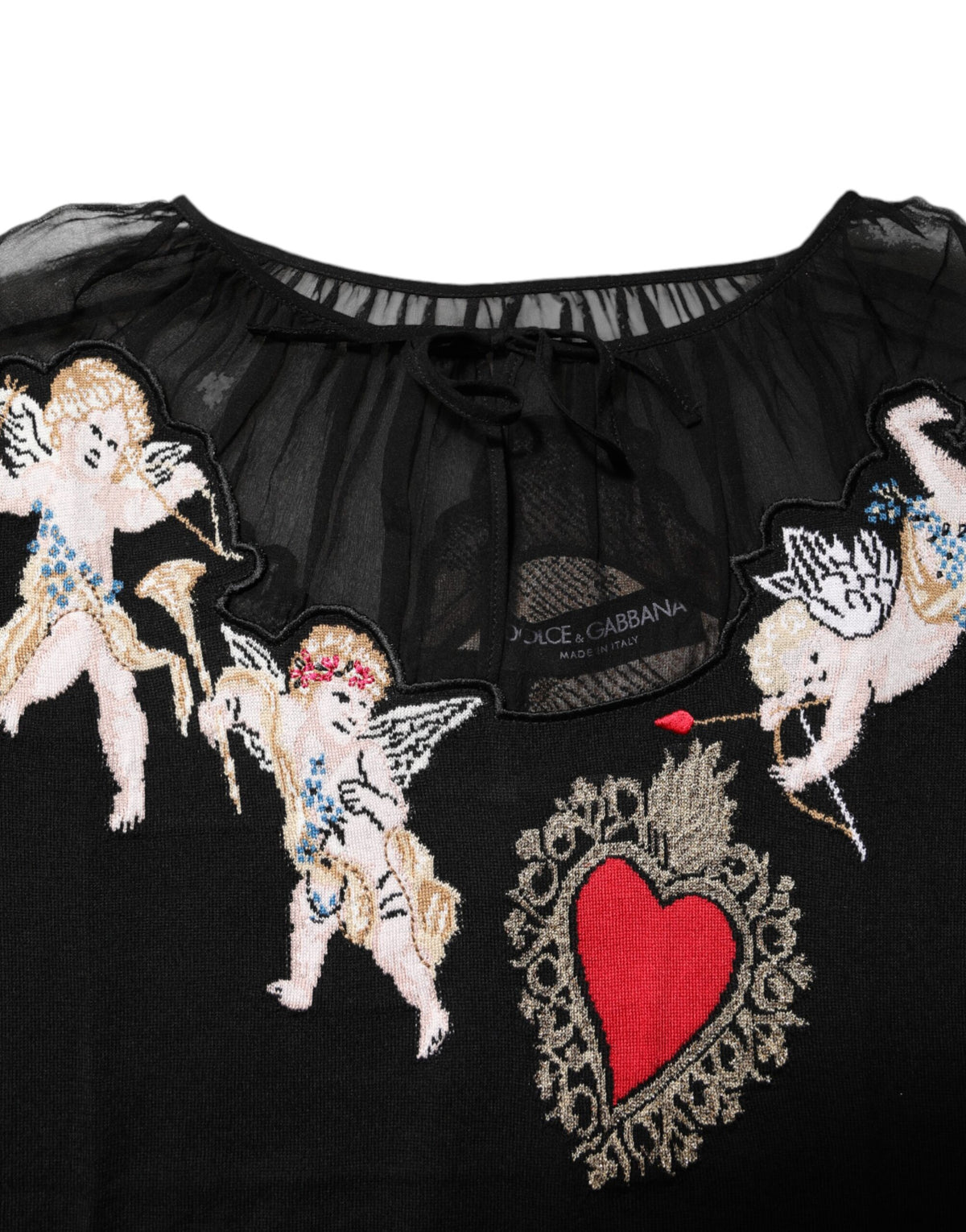 Experience the allure of the Dolce & Gabbana Black Sacred Heart Embroidered Crewneck Top, a masterpiece of virgin wool and silk, embodying timeless elegance and exquisite craftsmanship.