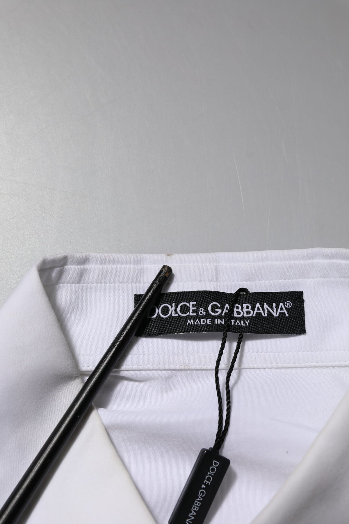 Elevate your wardrobe with the Dolce & Gabbana White Crystal Embellished Collared Shirt Top, a masterpiece of Italian craftsmanship in luxurious cotton, perfect for those who embody elegance and sophistication.