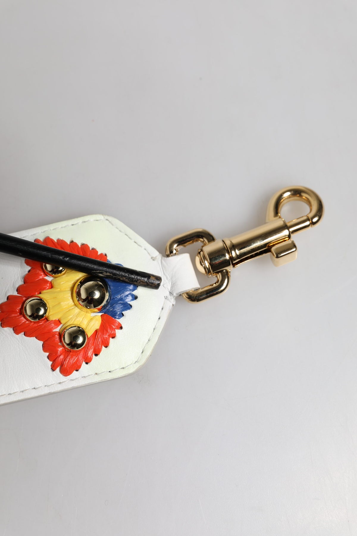 Elevate your style with the Dolce & Gabbana White Calfskin Raffia Embroidered Patchwork Shoulder Strap, a luxurious blend of artisanal craftsmanship and vibrant elegance, perfect for the discerning fashion connoisseur.