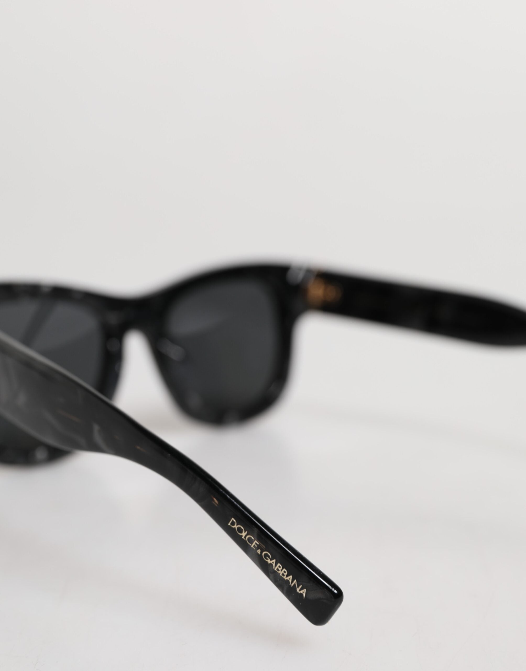 Indulge in the exquisite Dolce & Gabbana Pearl White Acetate Frame DG4379 sunglasses, where Italian craftsmanship meets timeless elegance for the discerning individual.