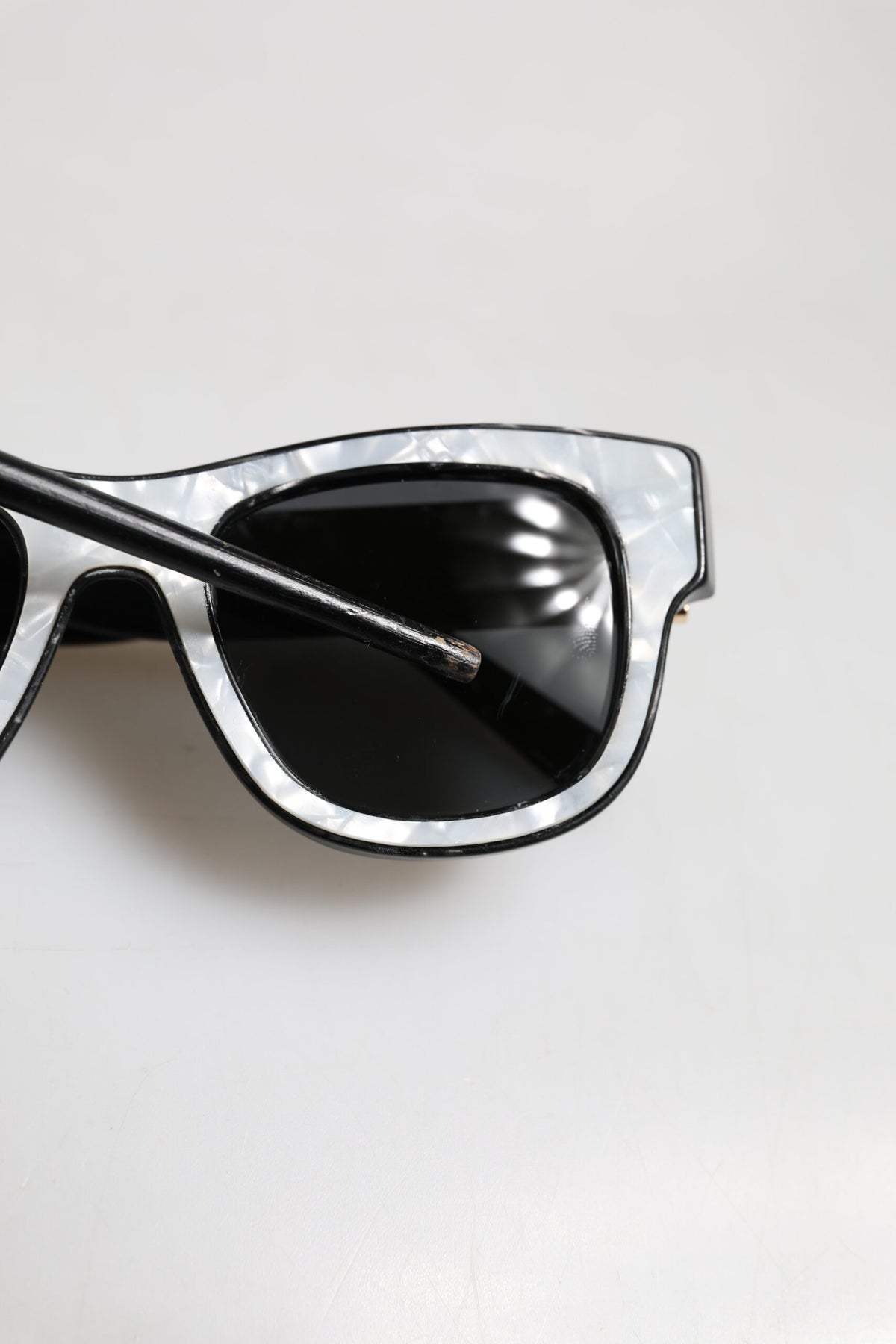 Indulge in the exquisite Dolce & Gabbana Pearl White Acetate Frame DG4379 sunglasses, a luxurious statement piece that embodies timeless elegance and Italian craftsmanship.