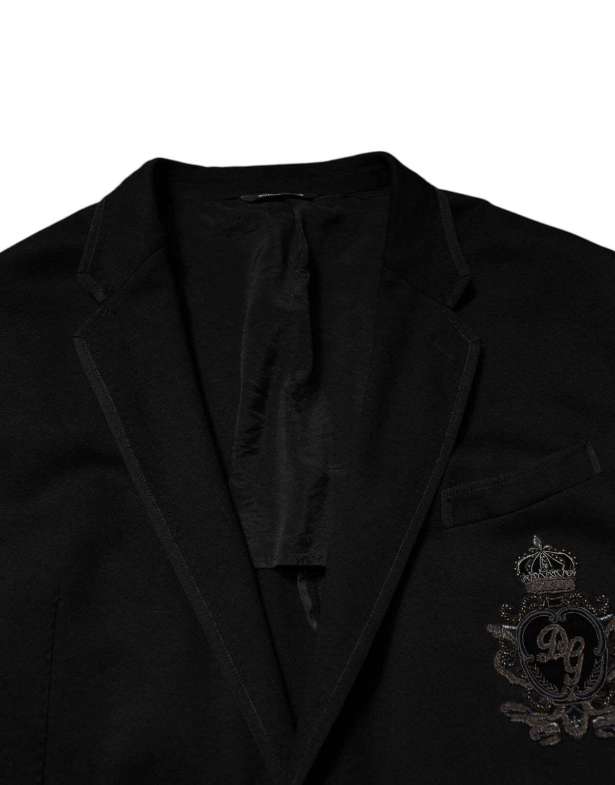 Elevate your wardrobe with the Dolce & Gabbana Black Viscose DG Crown Blazer, a masterpiece of Italian craftsmanship that embodies timeless luxury and sophisticated allure.