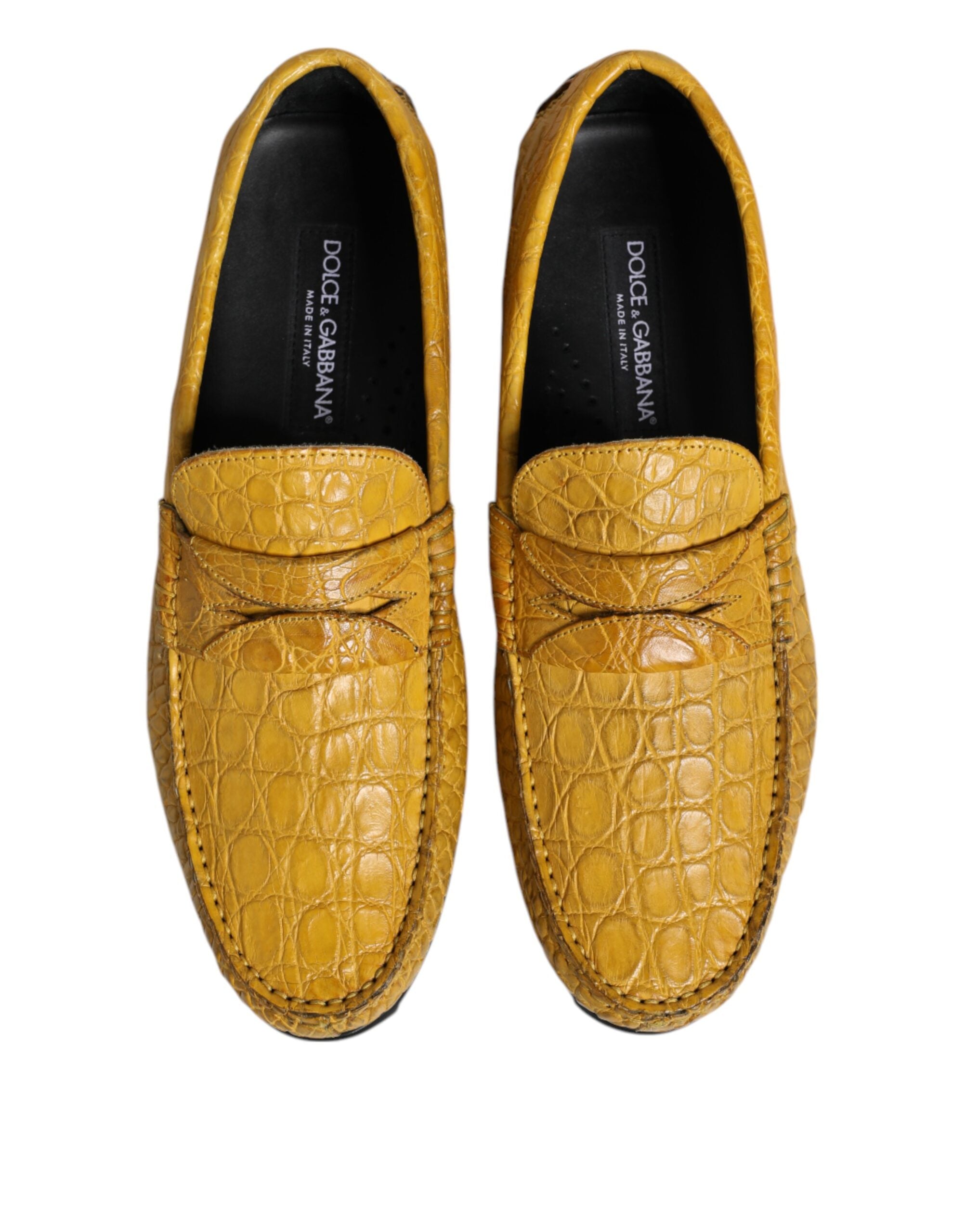 Step into a realm of elegance with Dolce & Gabbana's Yellow Exotic Leather Loafers, crafted from luxurious Caiman leather, embodying sophistication and timeless allure.
